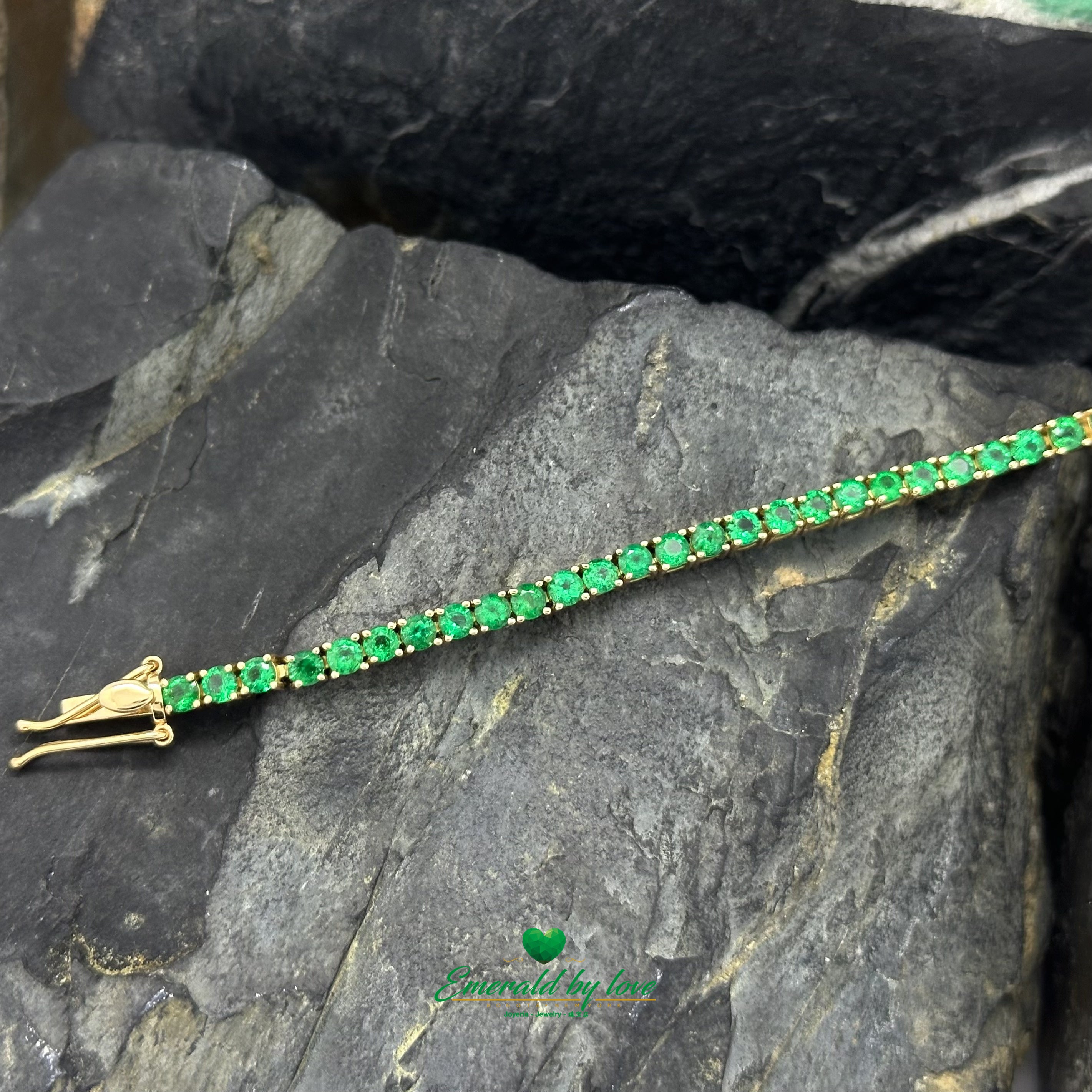 Handcrafted tennis bracelet with vivid green emeralds in gold