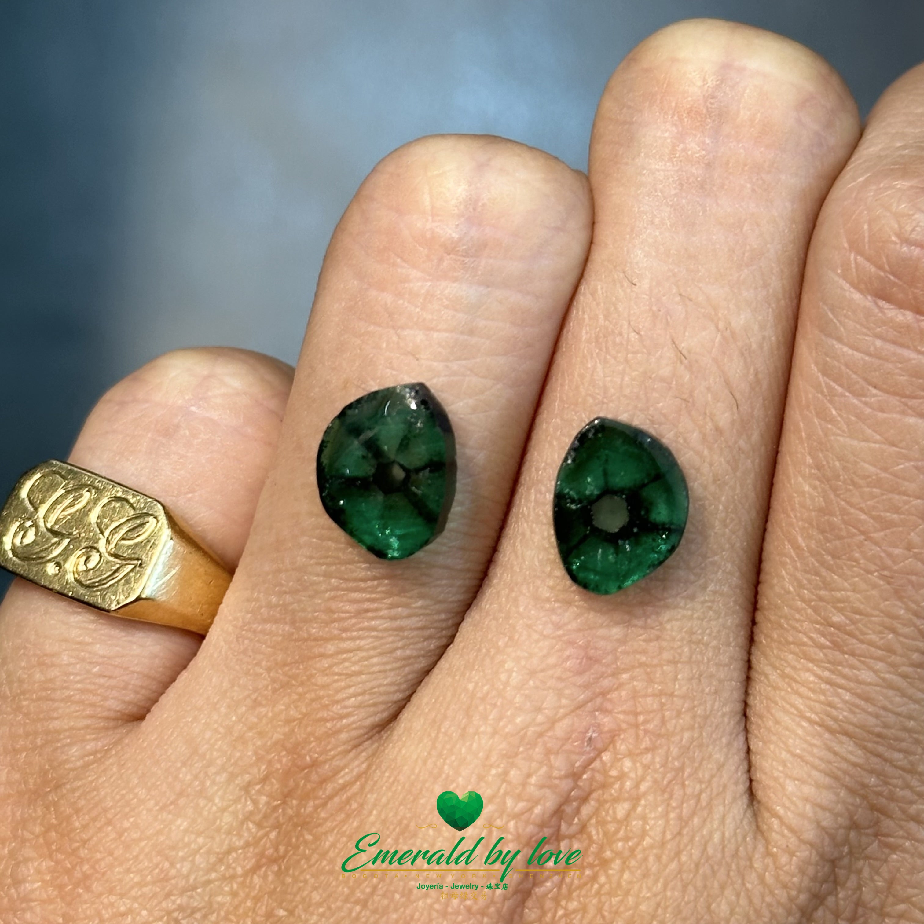 Unique pair of Colombian trapiche emeralds with visible natural rays and deep green hues