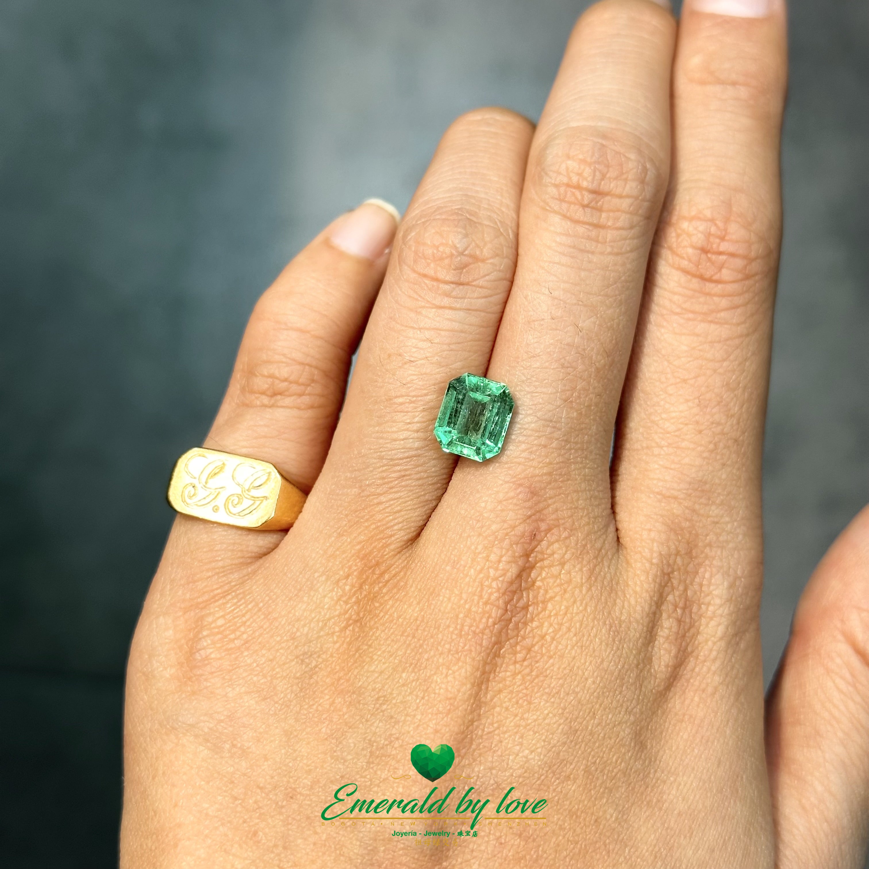 : Square Colombian emerald with bright green saturation and polished step-cut finish