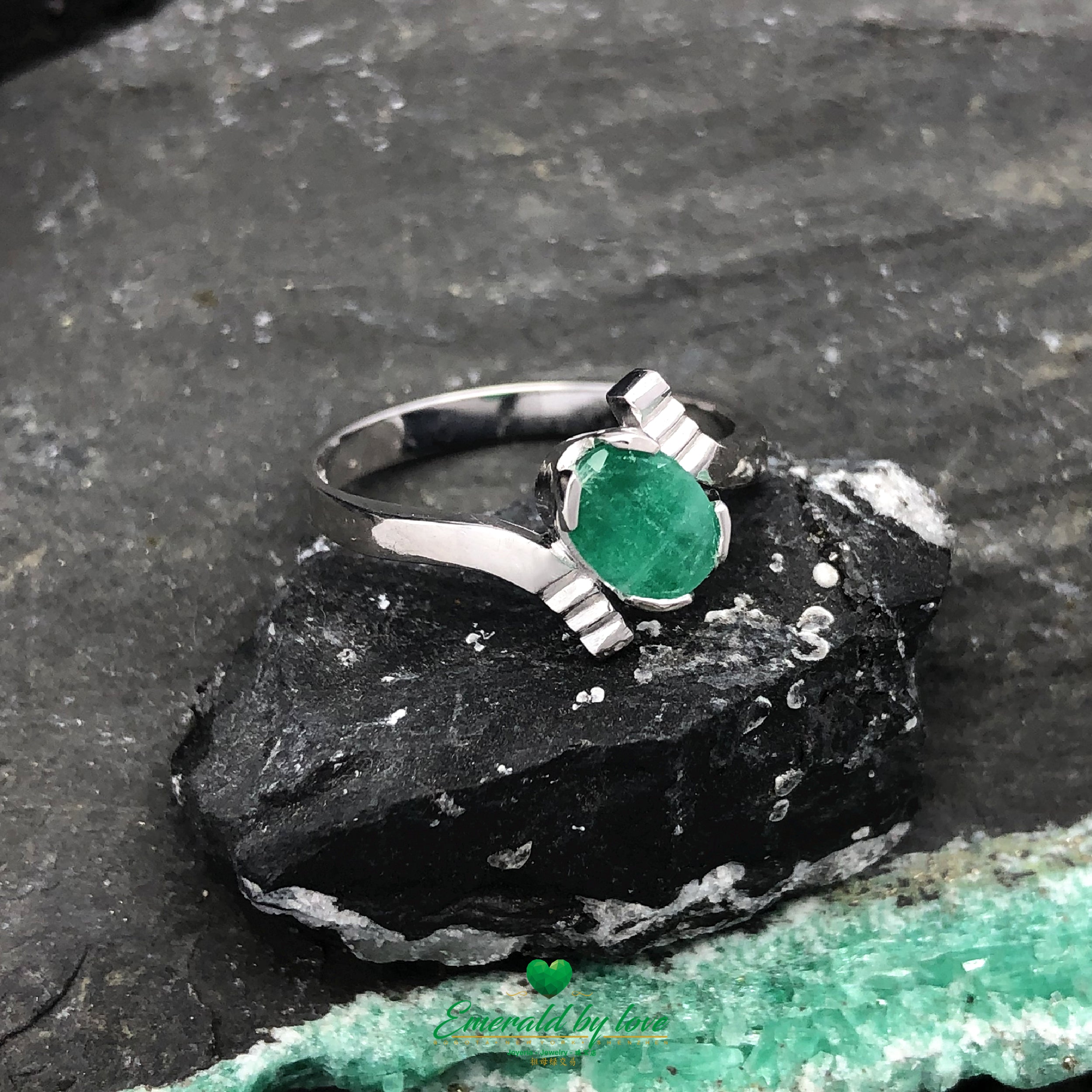 Celebrate your love with this sleek 18k gold ring featuring a Colombian emerald.