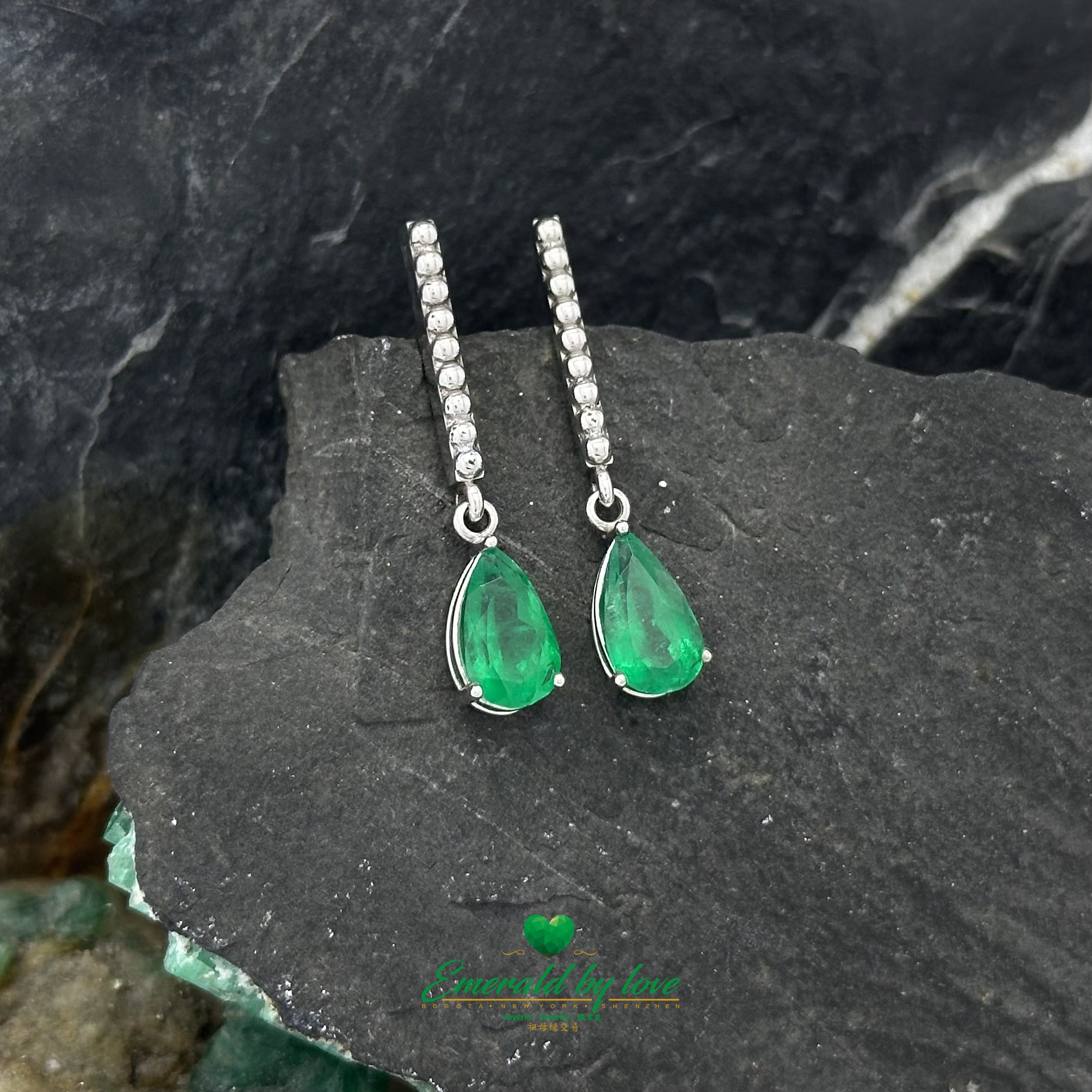 White Gold Serenity: Teardrop Emerald Earrings with Lengthwise Texture