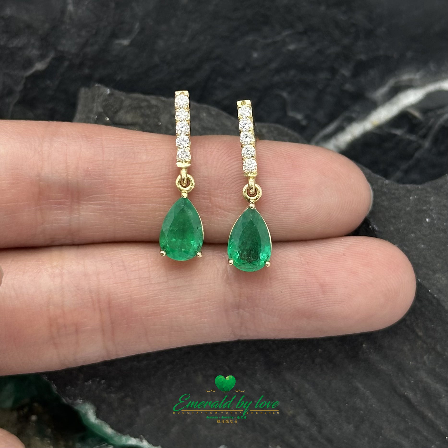 Elongated Yellow Gold Earrings Adorned with Diamond and Emerald Teardrop Accents