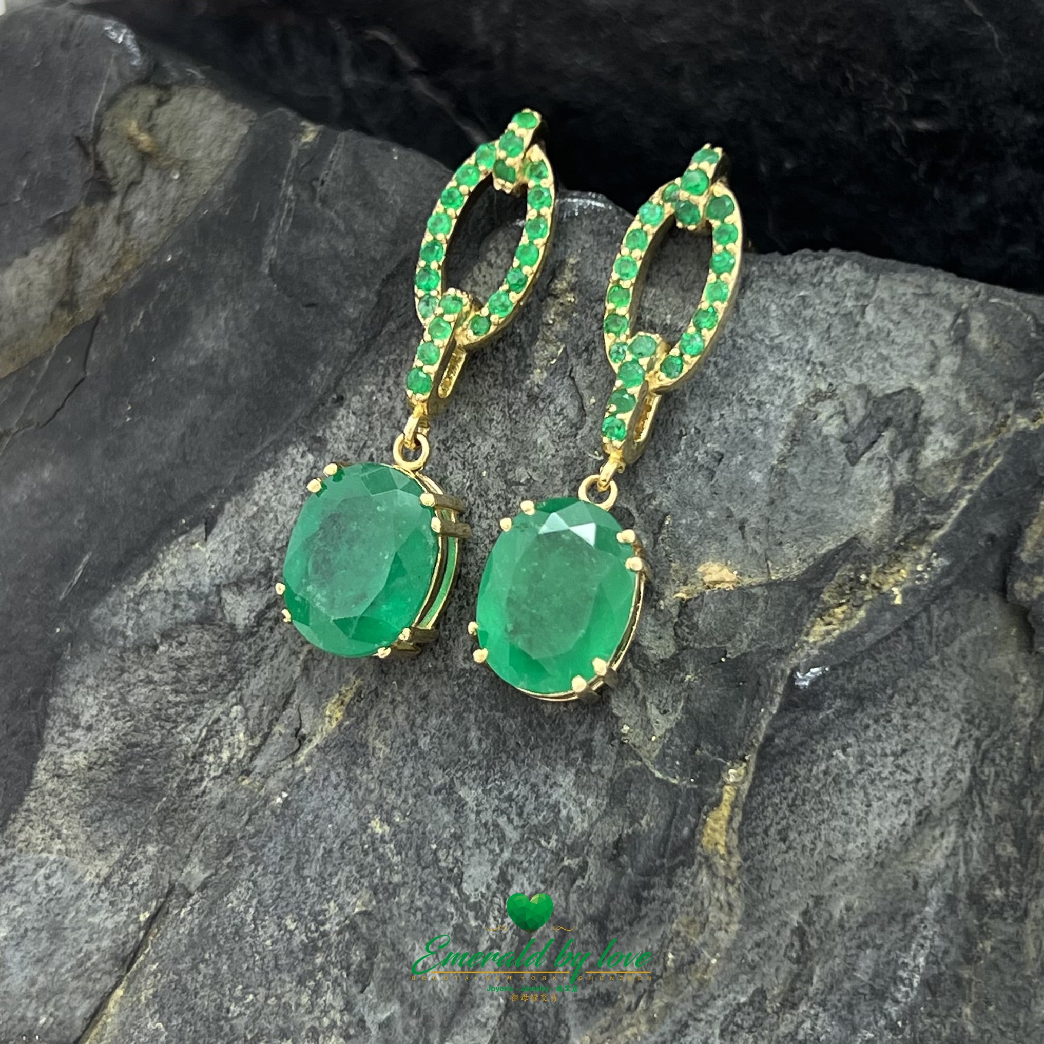 Boucles d'oreilles pendantes en or jaune avec de grandes émeraudes ovales et des accents d'émeraudes rondes
