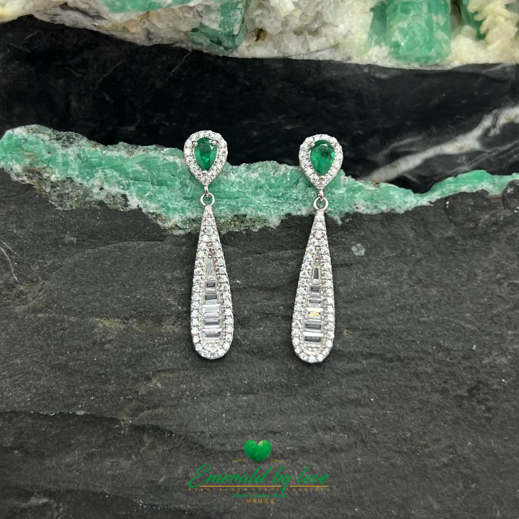Boucles d'oreilles pendantes allongées et élégantes avec de superbes émeraudes en forme de larme entourées