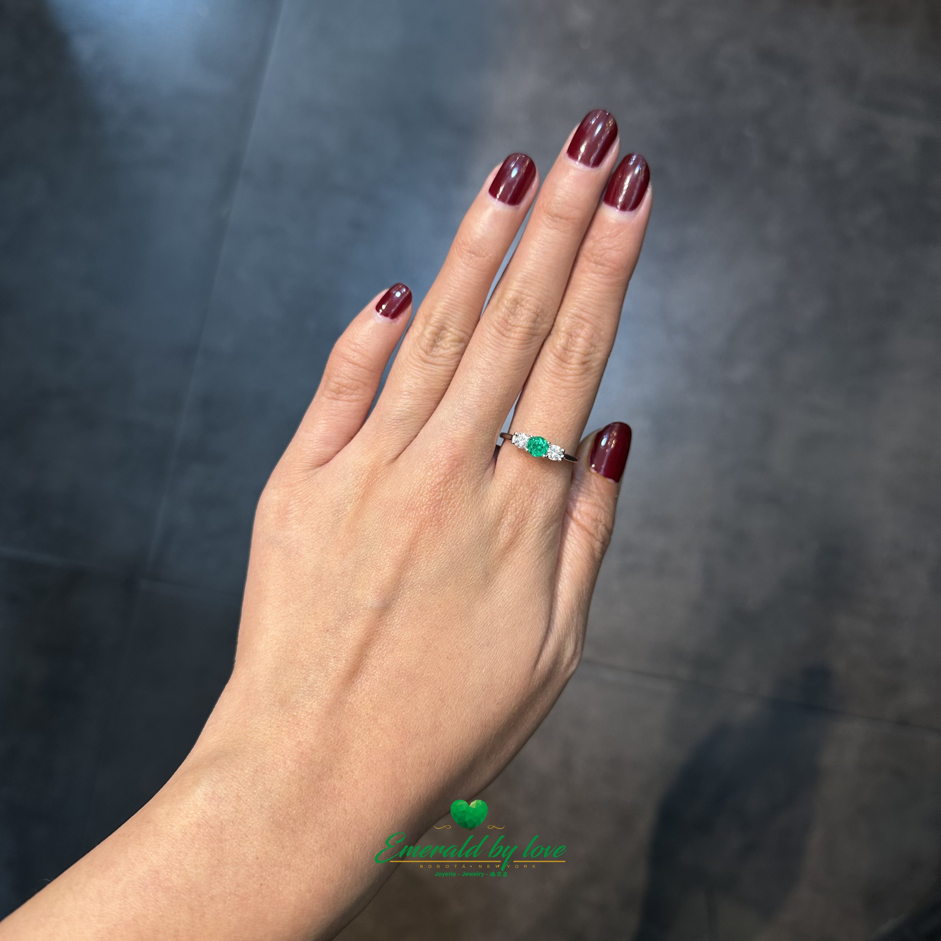 Sophisticated and classic, this ring highlights a deep green emerald and diamonds.