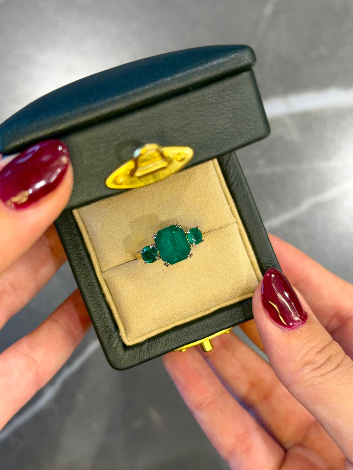 Yellow Gold Ring with Emerald Cut Colombian Emerald and Round Emerald Accents