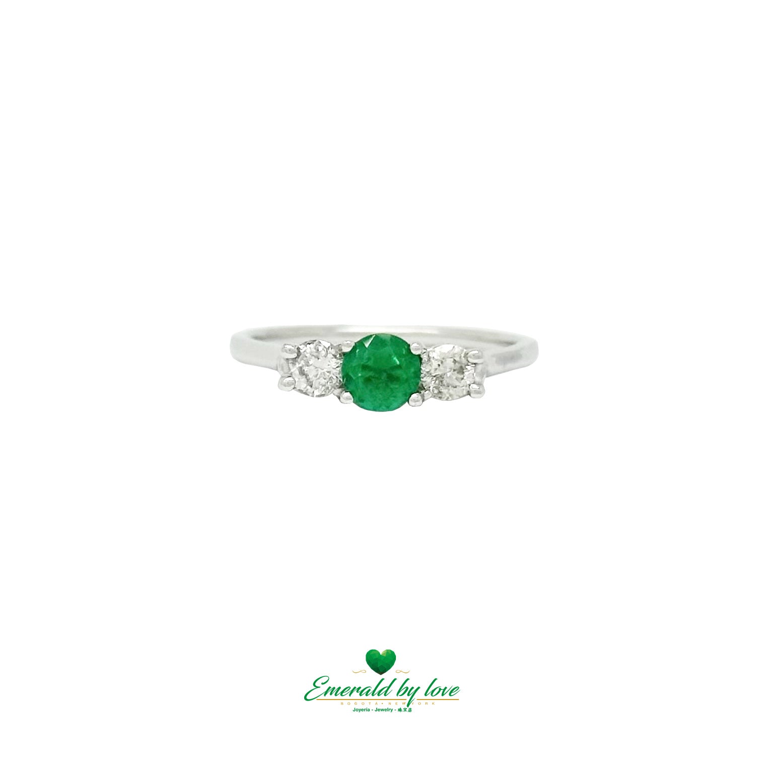 Crafted in 18K gold, this ring pairs a vivid Colombian emerald with sparkling diamond accents.