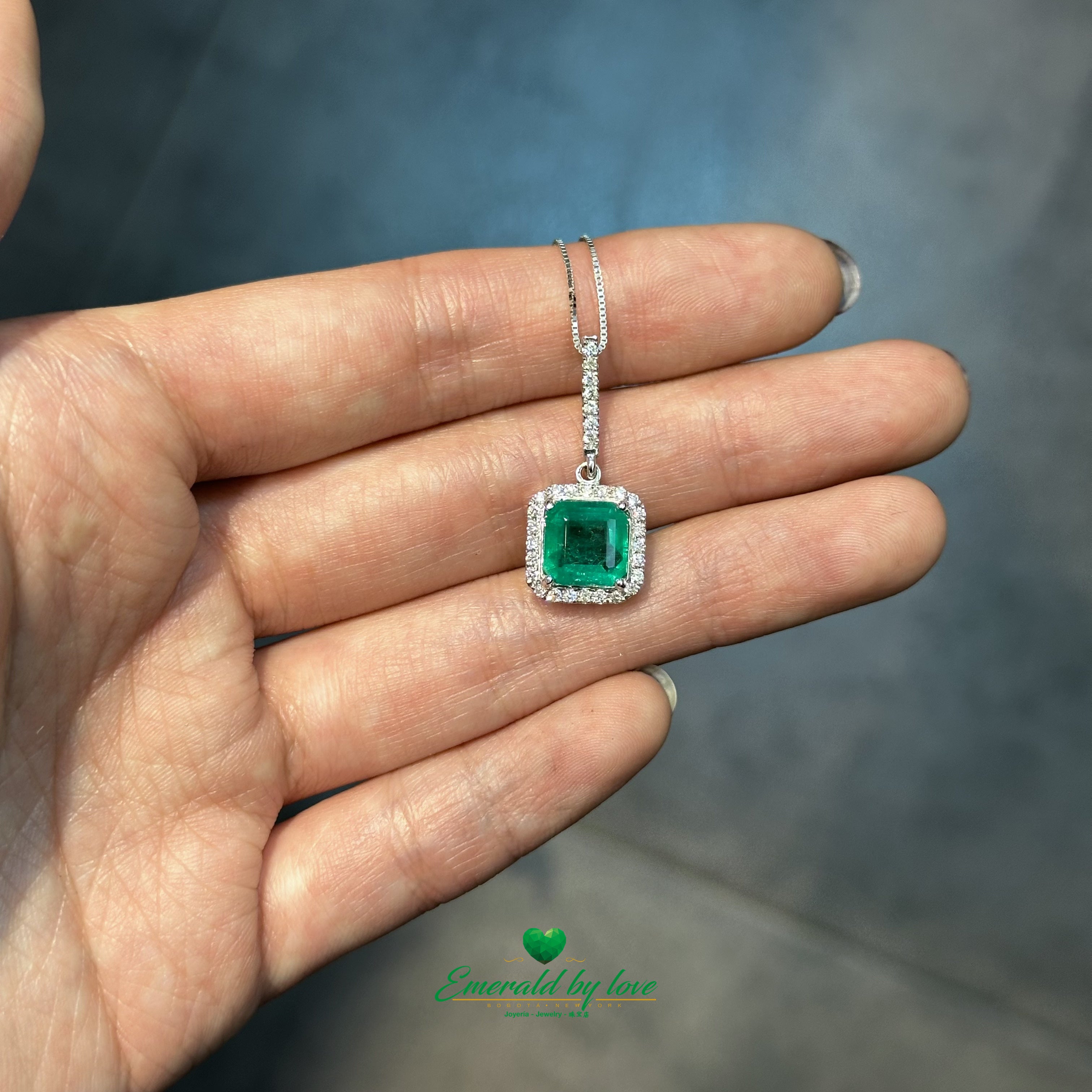 Elegant Emerald-Cut Colombian Emerald Pendant in 18K White Gold with Diamond Halo and Bail Accents