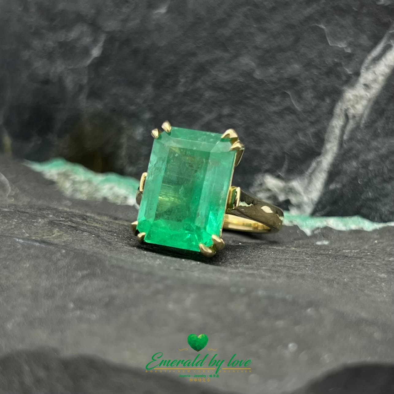 Magnificent Majesty: Yellow Gold Ring with Spectacular Emerald-Cut Emerald Centerpiece