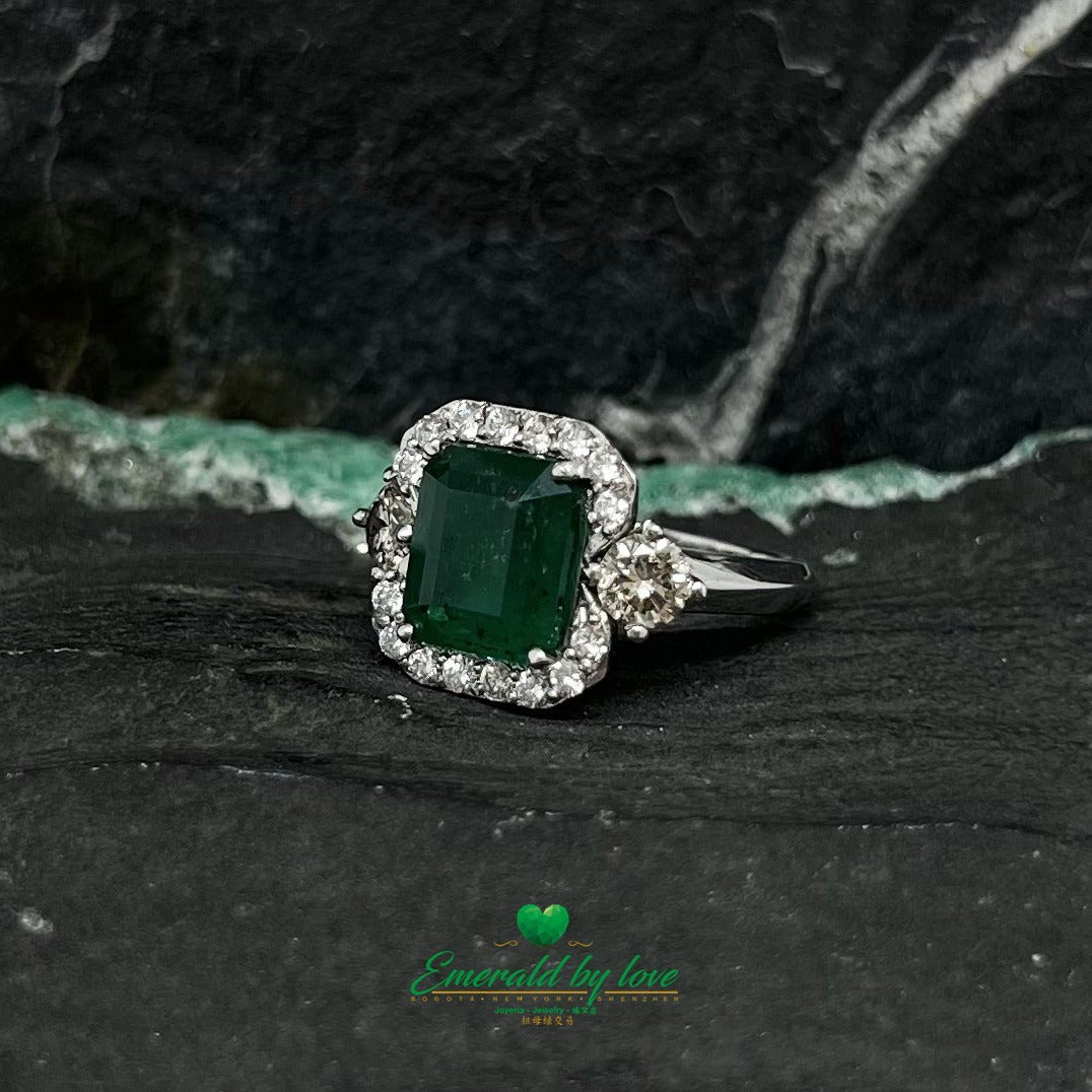 White Gold Ring with Emerald Cut Emerald Center, Flanked by Two Medium Diamonds, and Surrounded by Small Diamonds