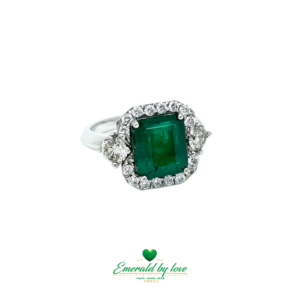 White Gold Ring with Emerald Cut Emerald Center, Flanked by Two Medium Diamonds, and Surrounded by Small Diamonds