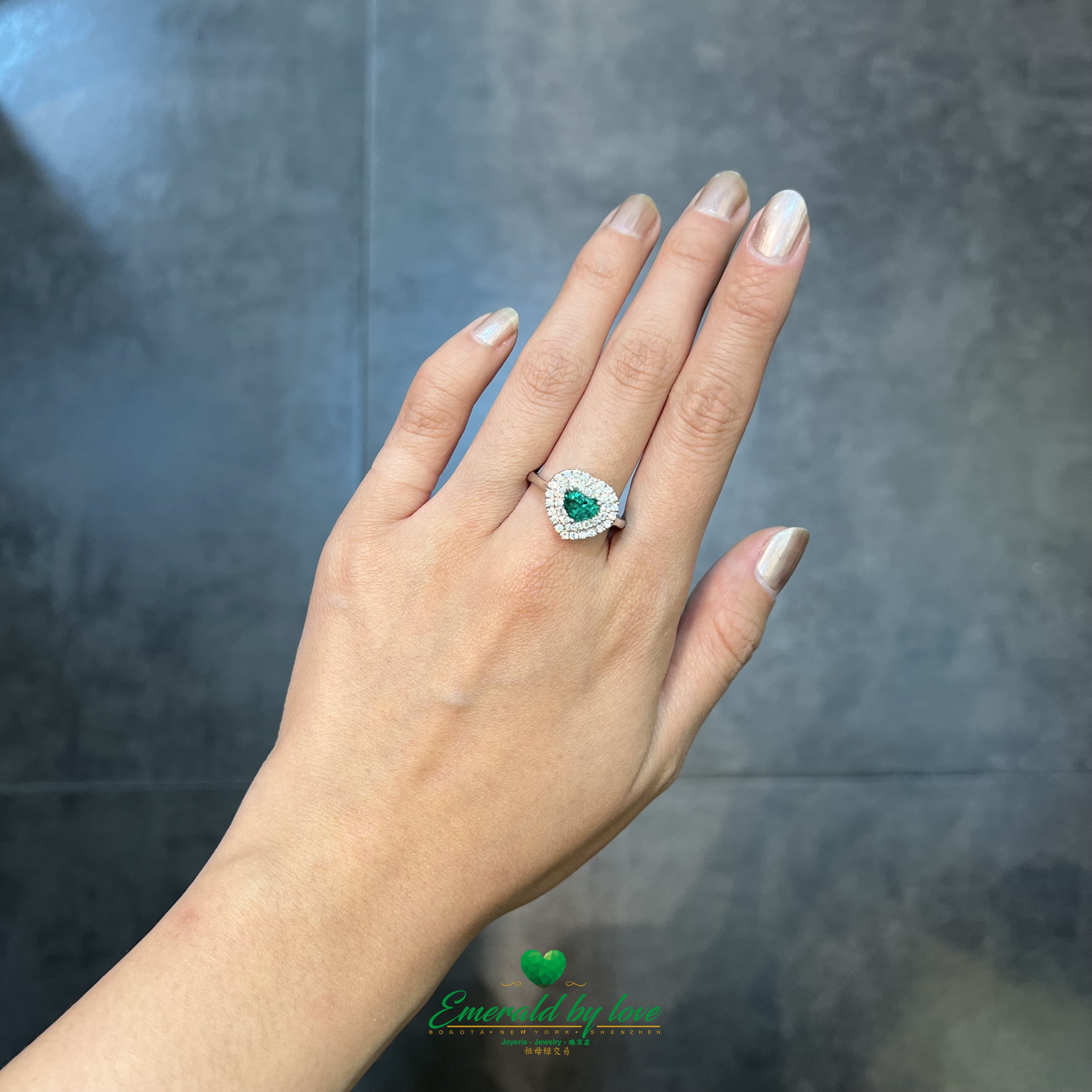 Bague en or blanc avec rangées d'émeraude et de diamants en forme de cœur
