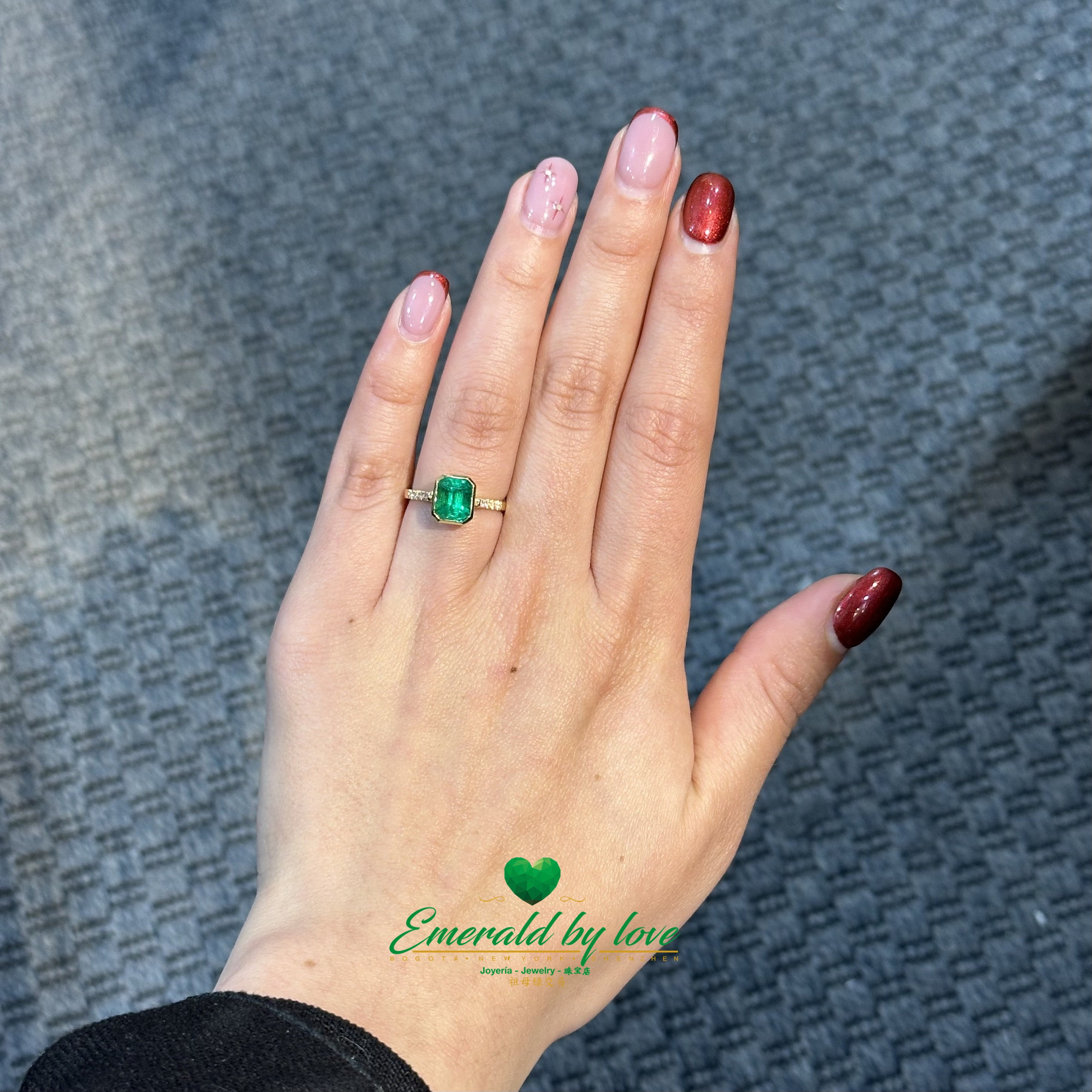 Elegant Bezel-Set Emerald-Cut Emerald Engagement Ring with Diamond Band