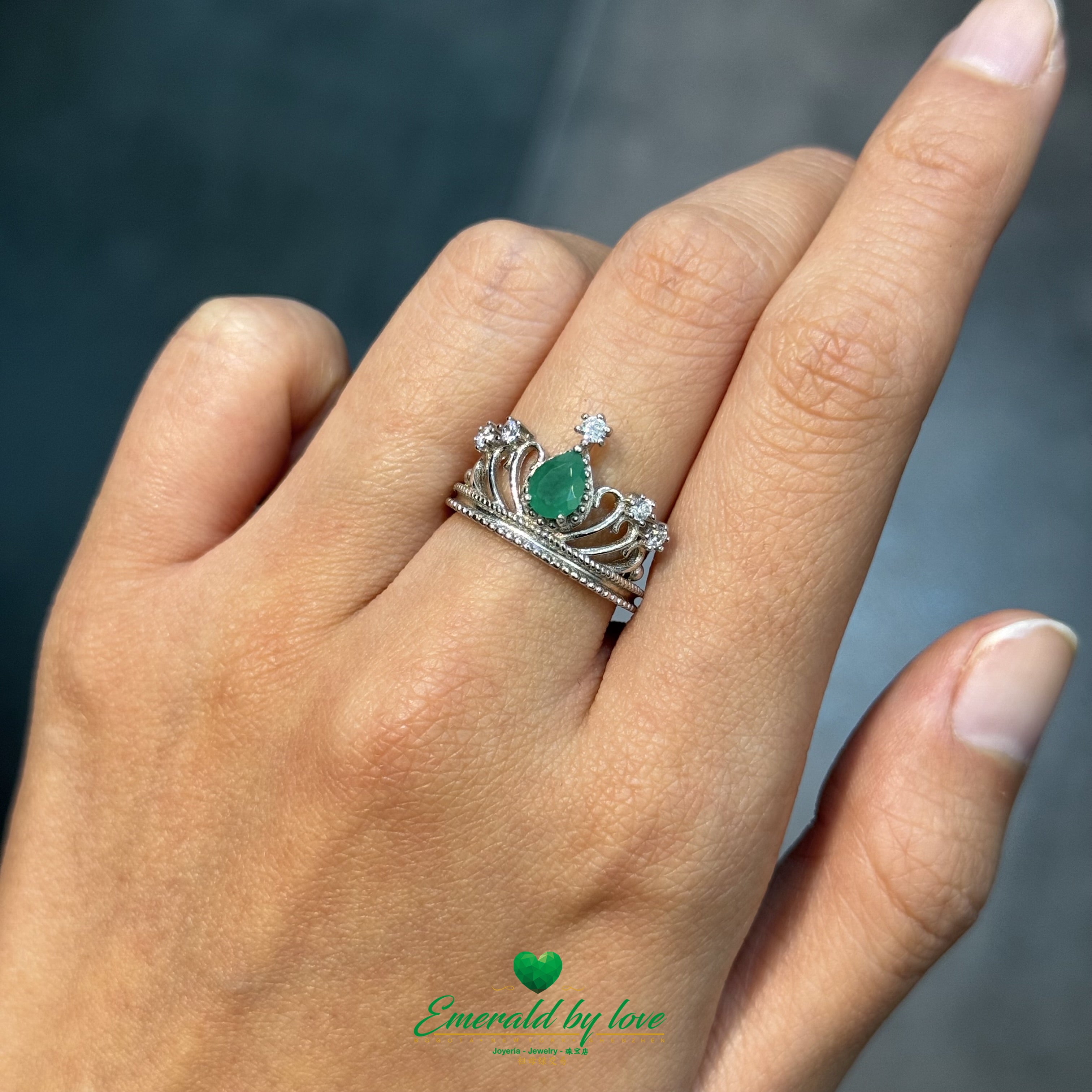 Crown-Inspired Ring with Pear-Shaped Emerald Center and Decorative Zircons