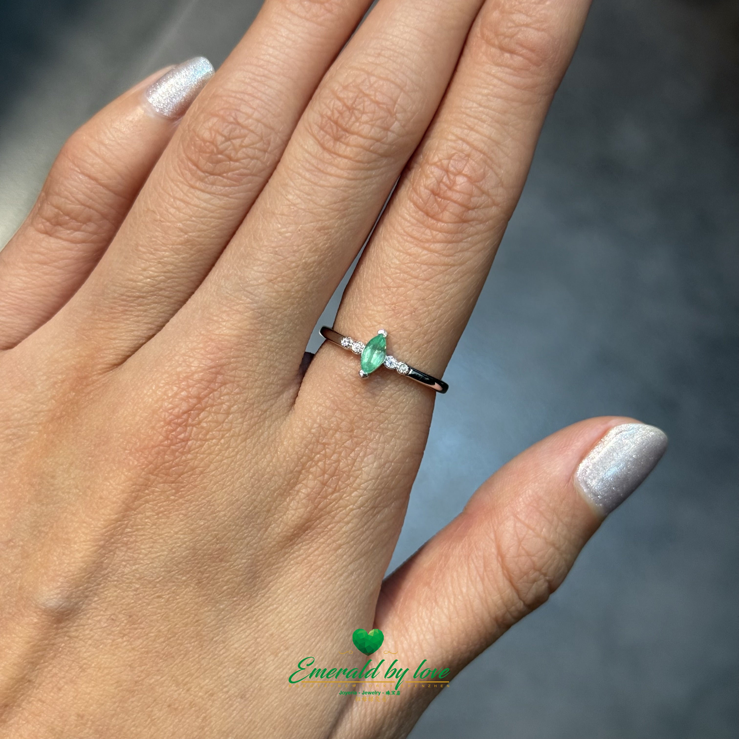 Sterling Silver Solitaire Ring with Marquise-Cut Emerald and Cubic Zirconia Band