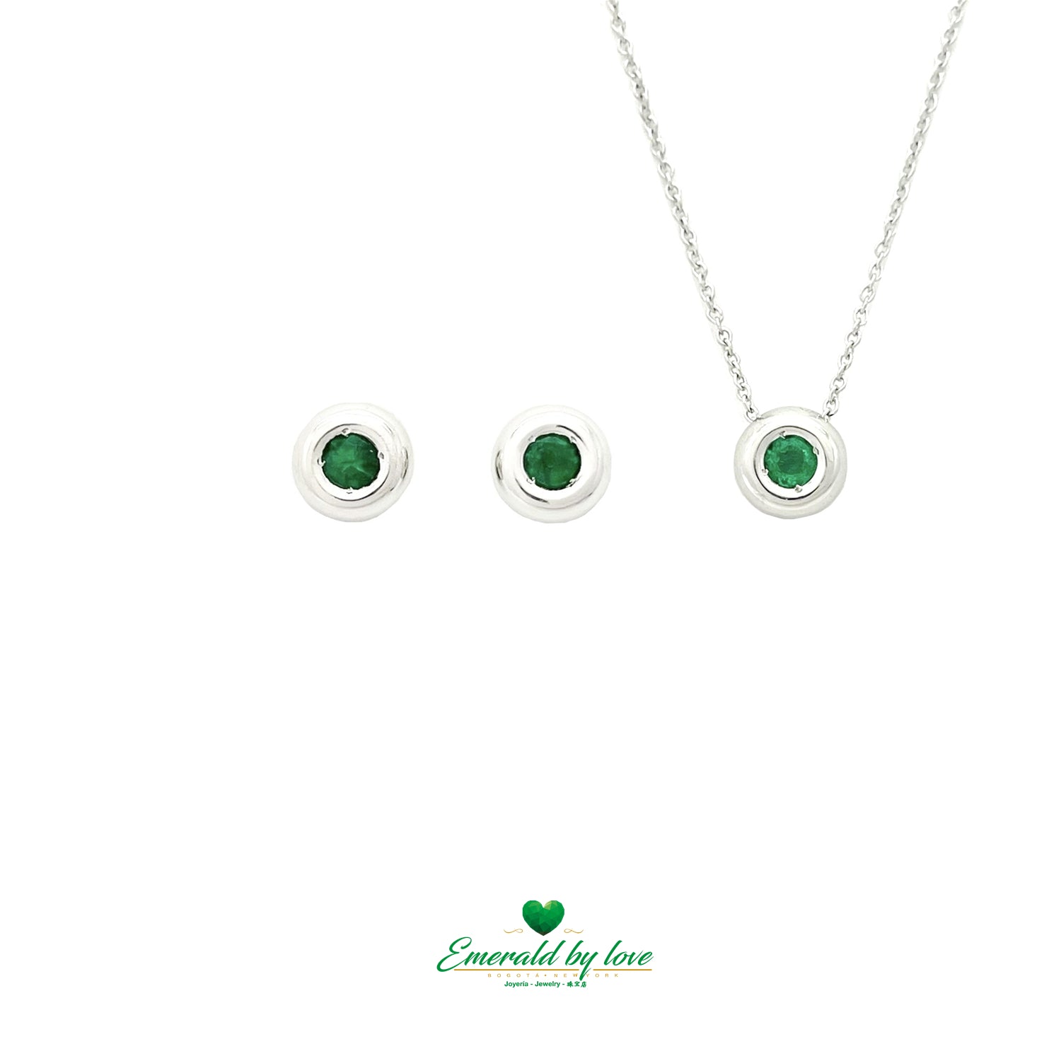 Conjunto de joyas de oro blanco con pendientes redondos y colgante con esmeralda central