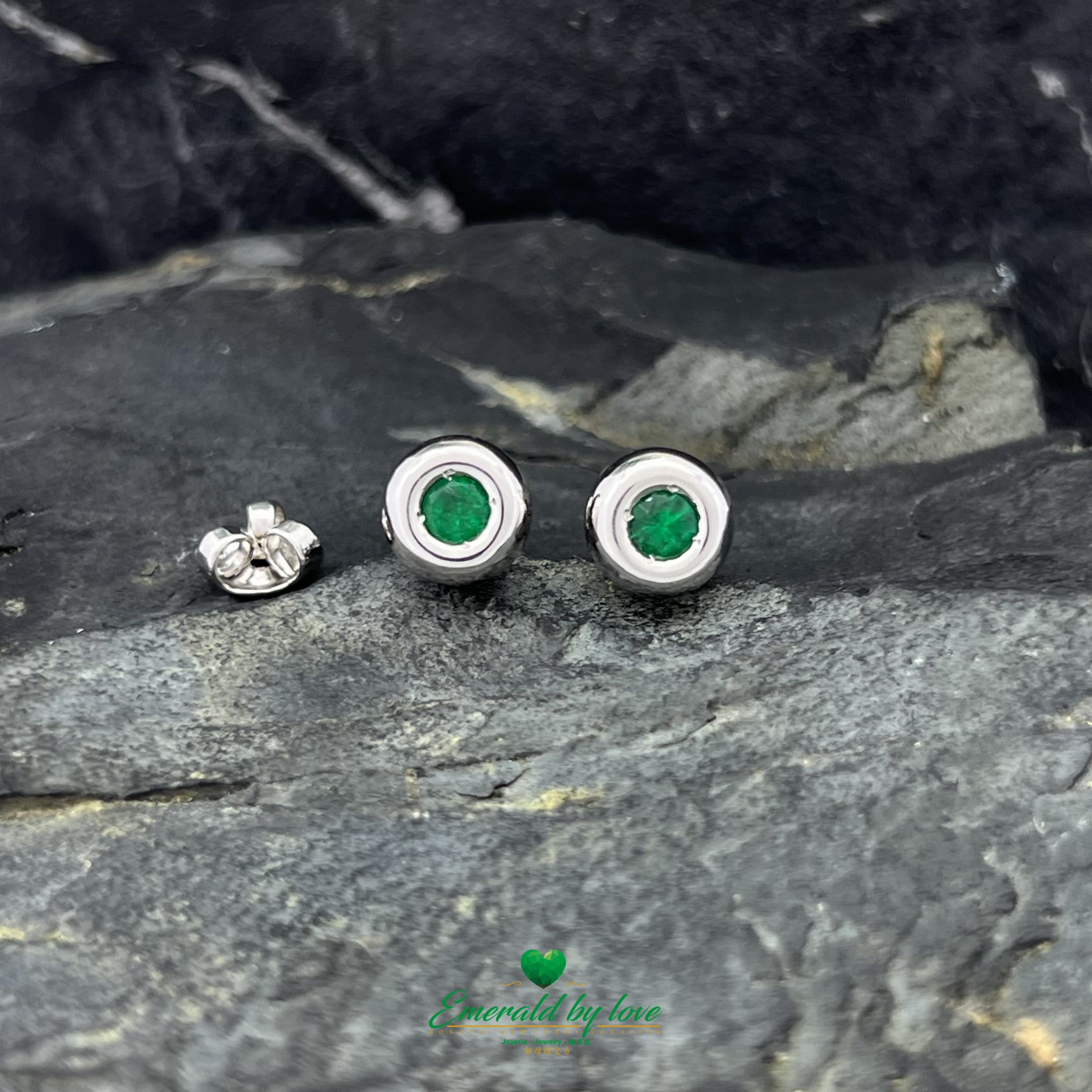 Conjunto de joyas de oro blanco con pendientes redondos y colgante con esmeralda central