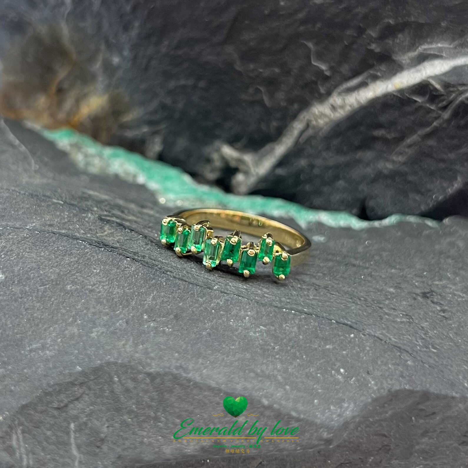Hermoso anillo de oro amarillo con esmeraldas baguette de diseño uniforme