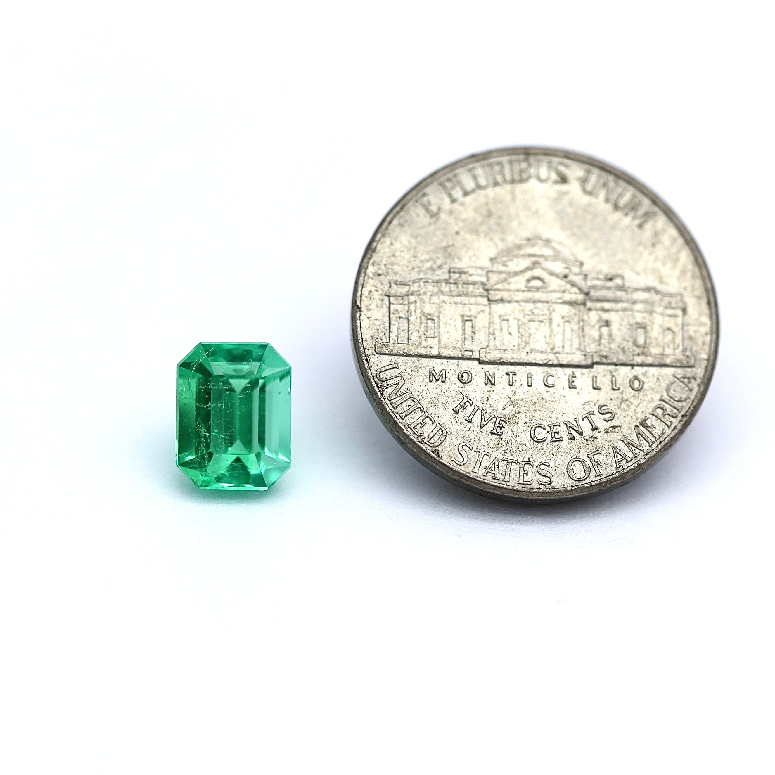 comparison coin with colombian emerald cut 