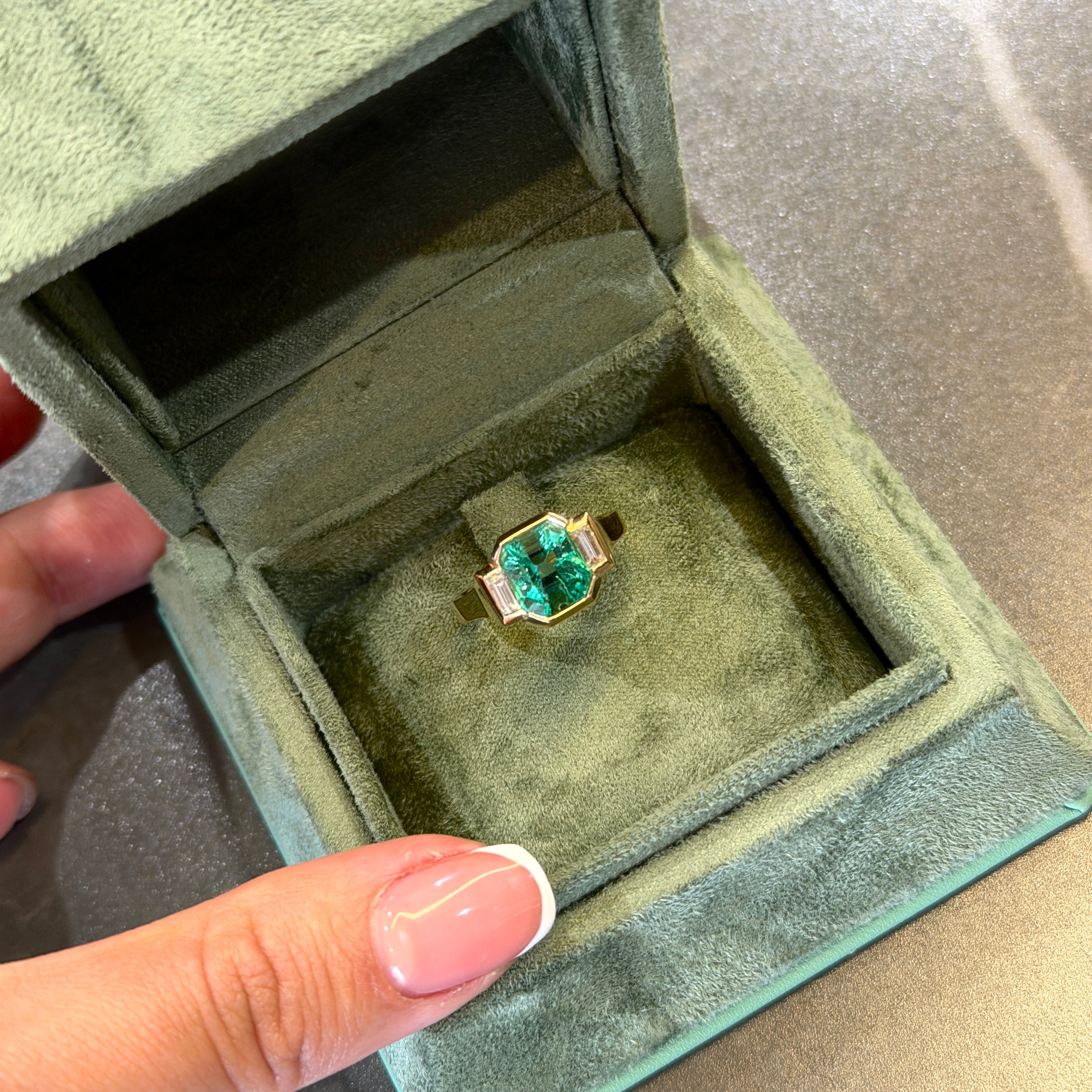 Elegant Colombian Emerald Bezel Ring in Yellow Gold with Diamond Baguette Side Stones