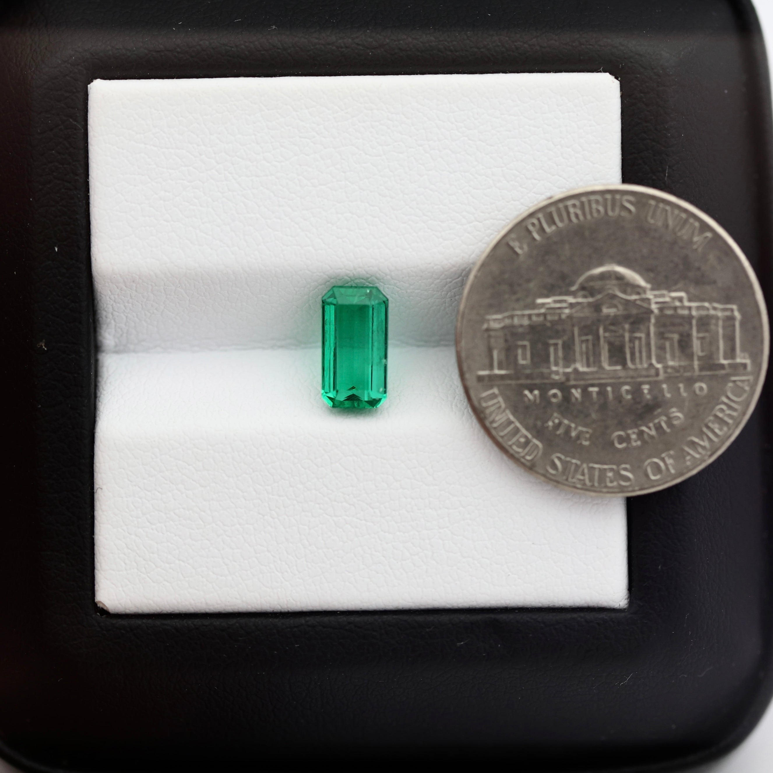 emerald with coin to measurements 