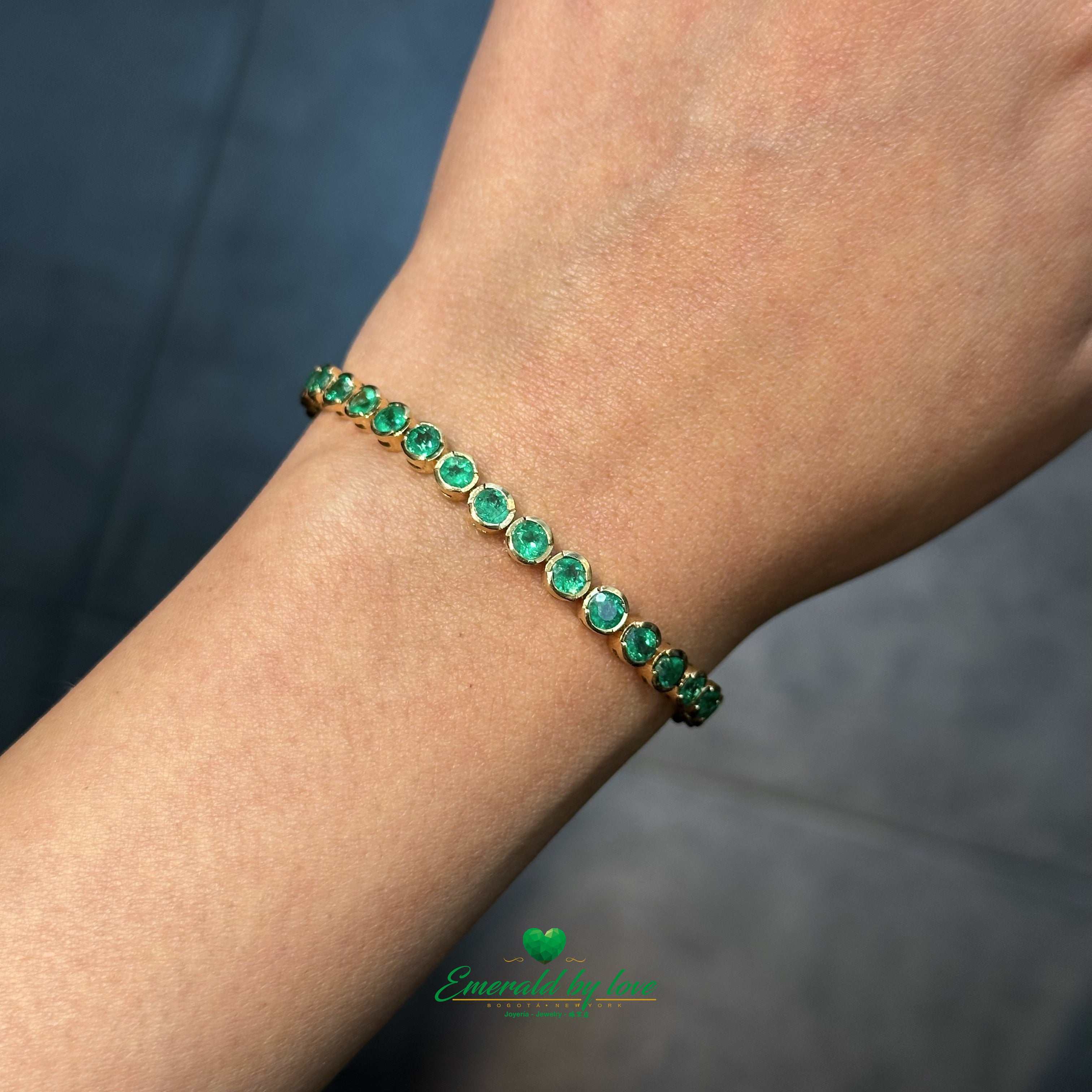 Minimalist 18K gold tennis bracelet with bezel-set Colombian emeralds