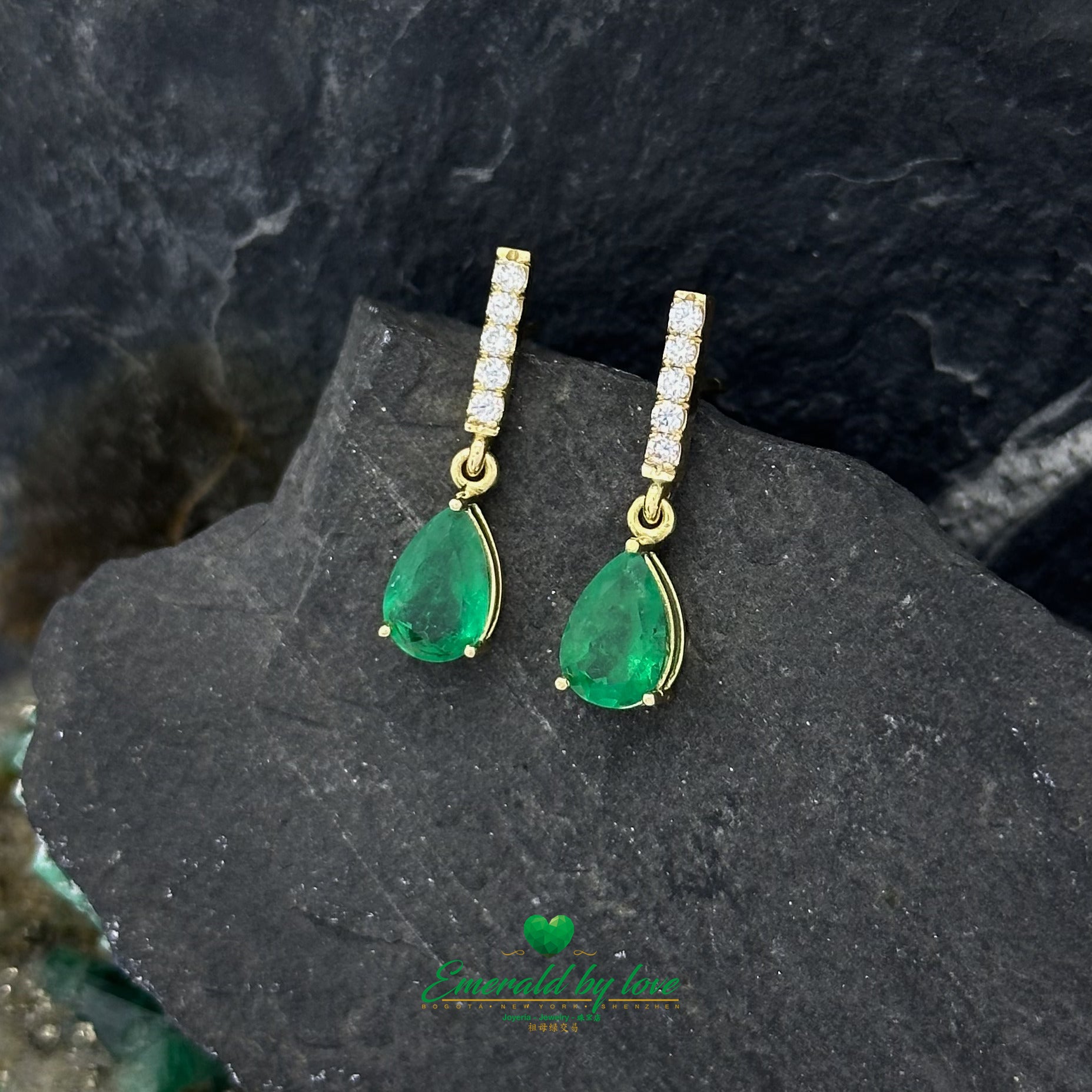 Elongated Yellow Gold Earrings Adorned with Diamond and Emerald Teardrop Accents