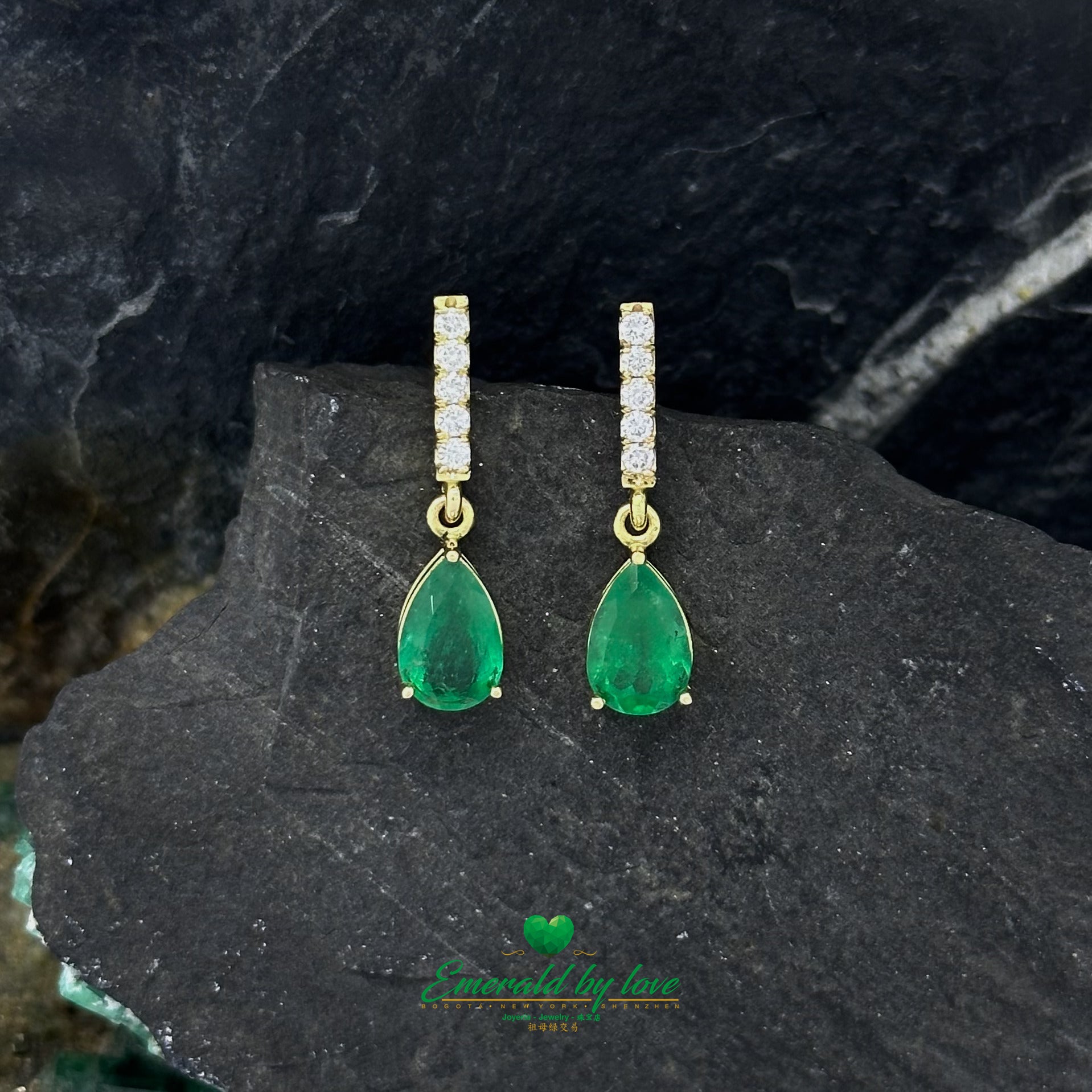 Elongated Yellow Gold Earrings Adorned with Diamond and Emerald Teardrop Accents