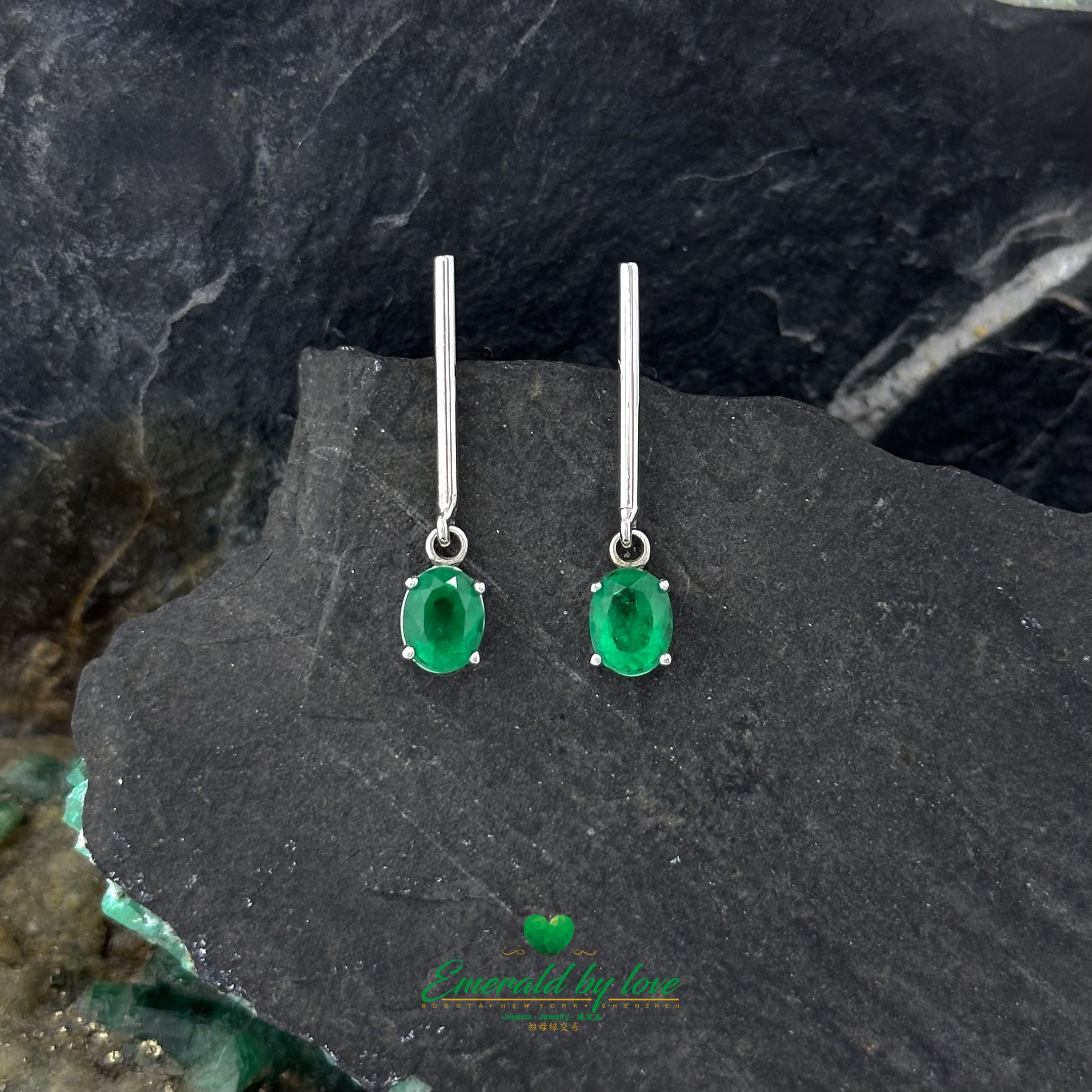 Timeless Glamour: Long White Gold Earrings with Oval Emeralds