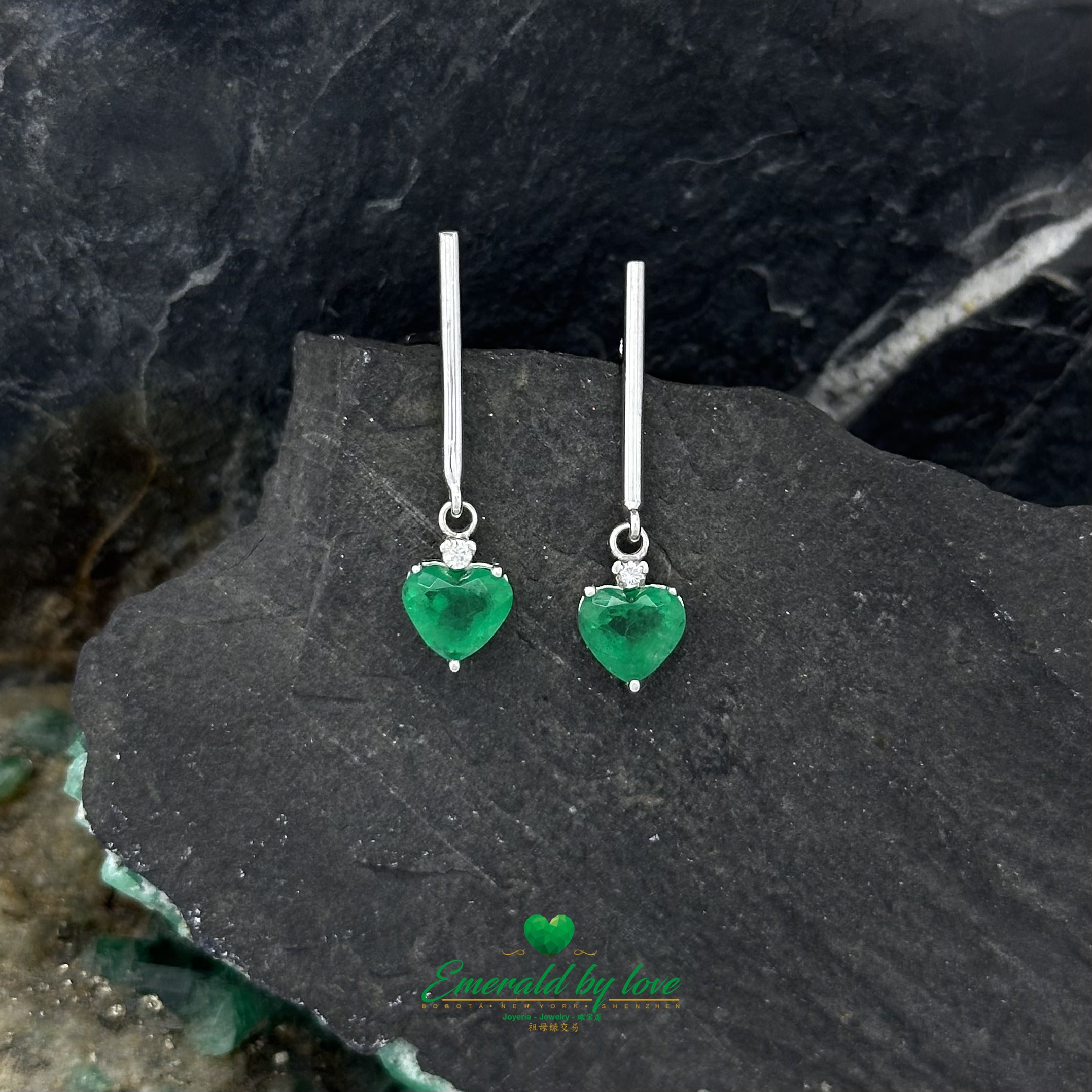 Heartfelt Radiance: Long White Gold Earrings with Heart-Shaped Emeralds