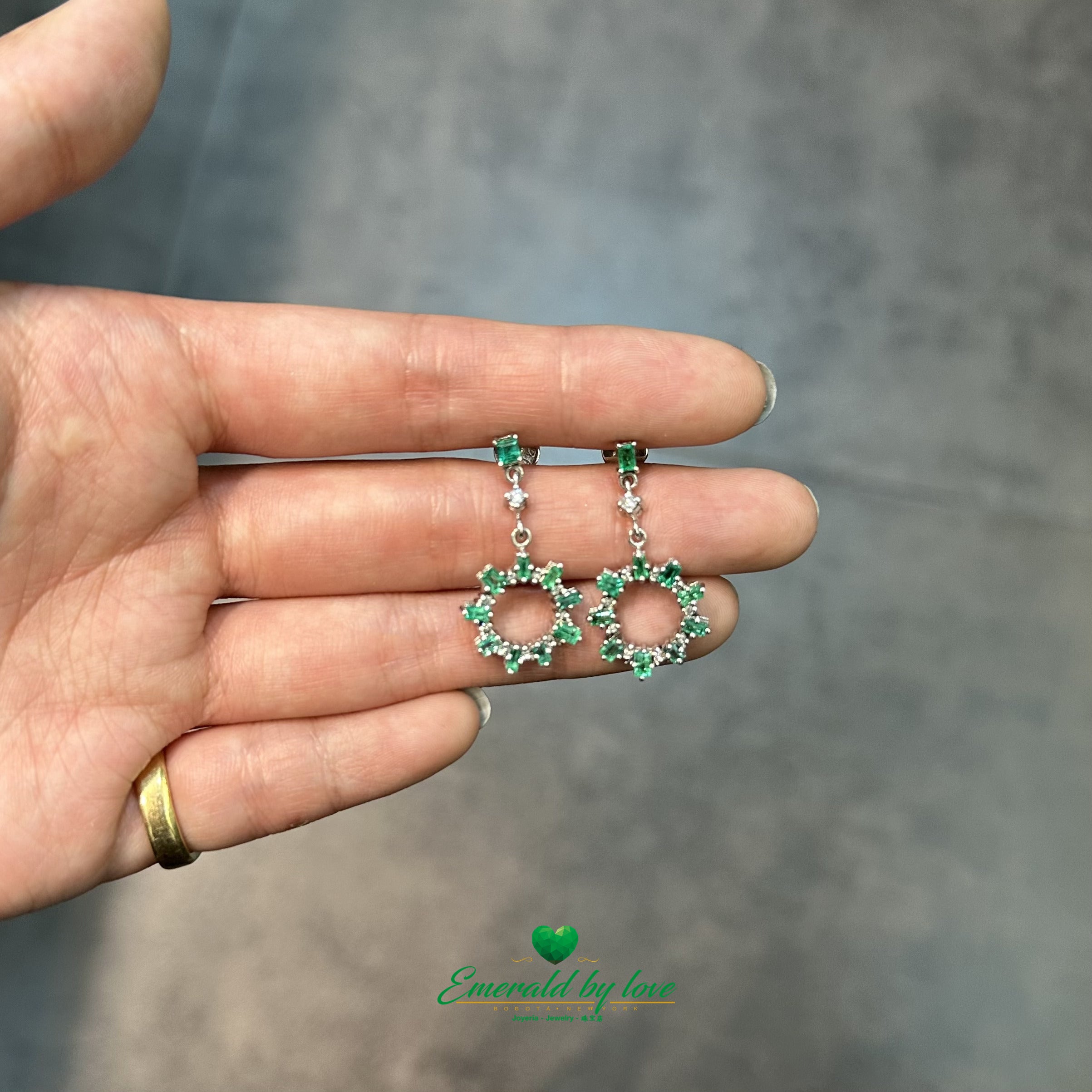 Elongated Earrings in White Gold with Baguette Emeralds, Diamonds, and Sunburst Detailing