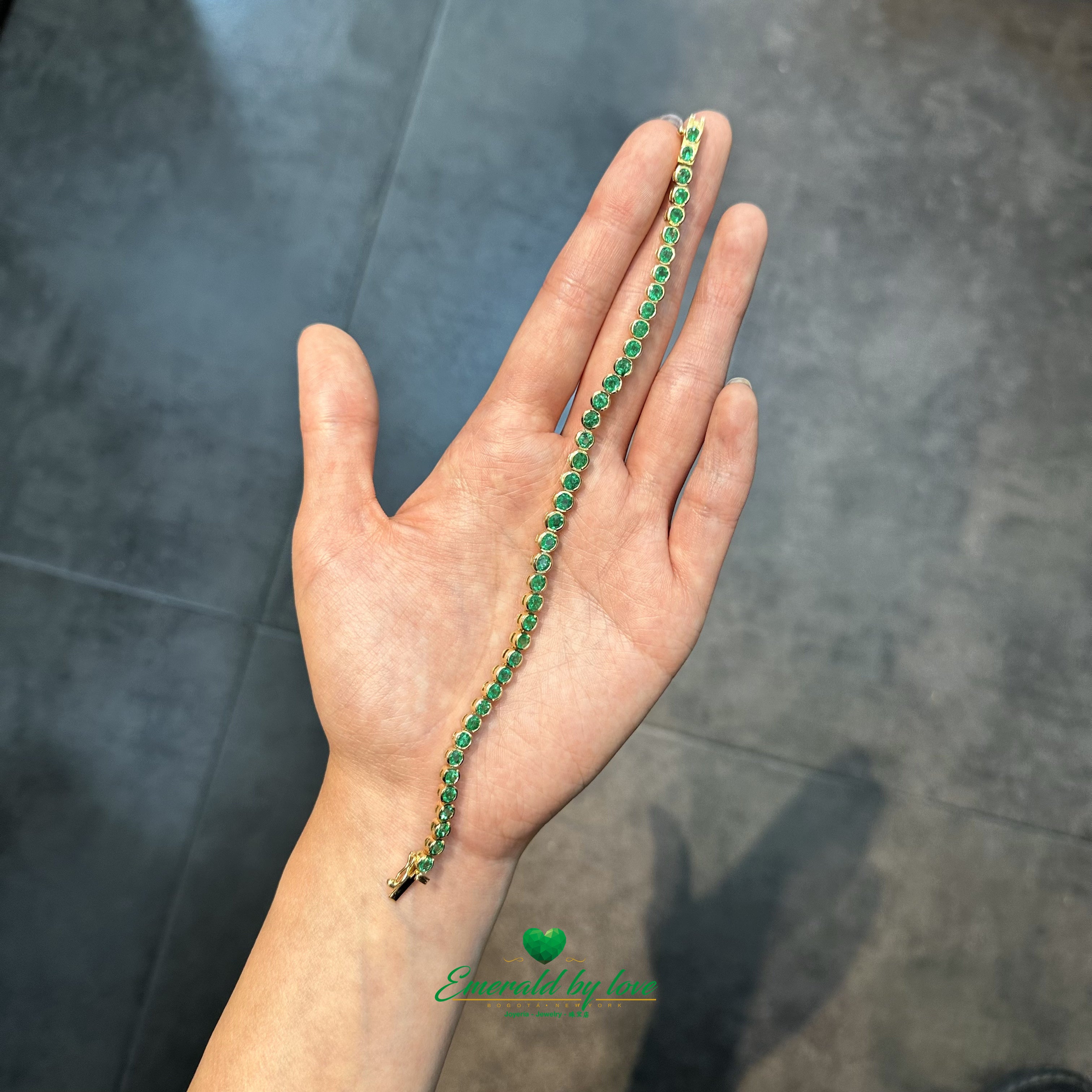 Round Colombian emerald bracelet in secure bezel gold setting