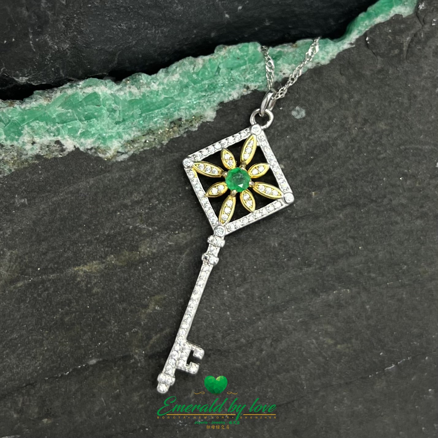 Gold-Plated Key Pendant with Flower Accent and Round Central Emerald