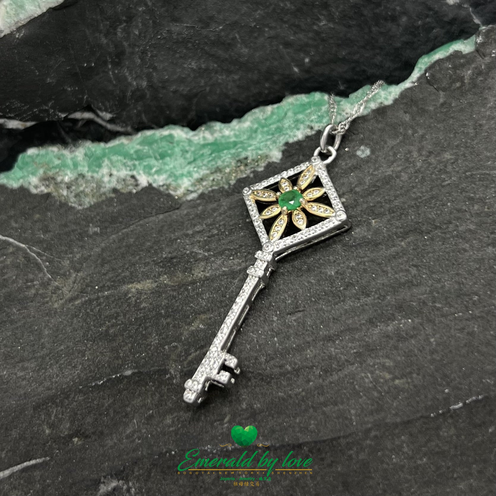 Gold-Plated Key Pendant with Flower Accent and Round Central Emerald