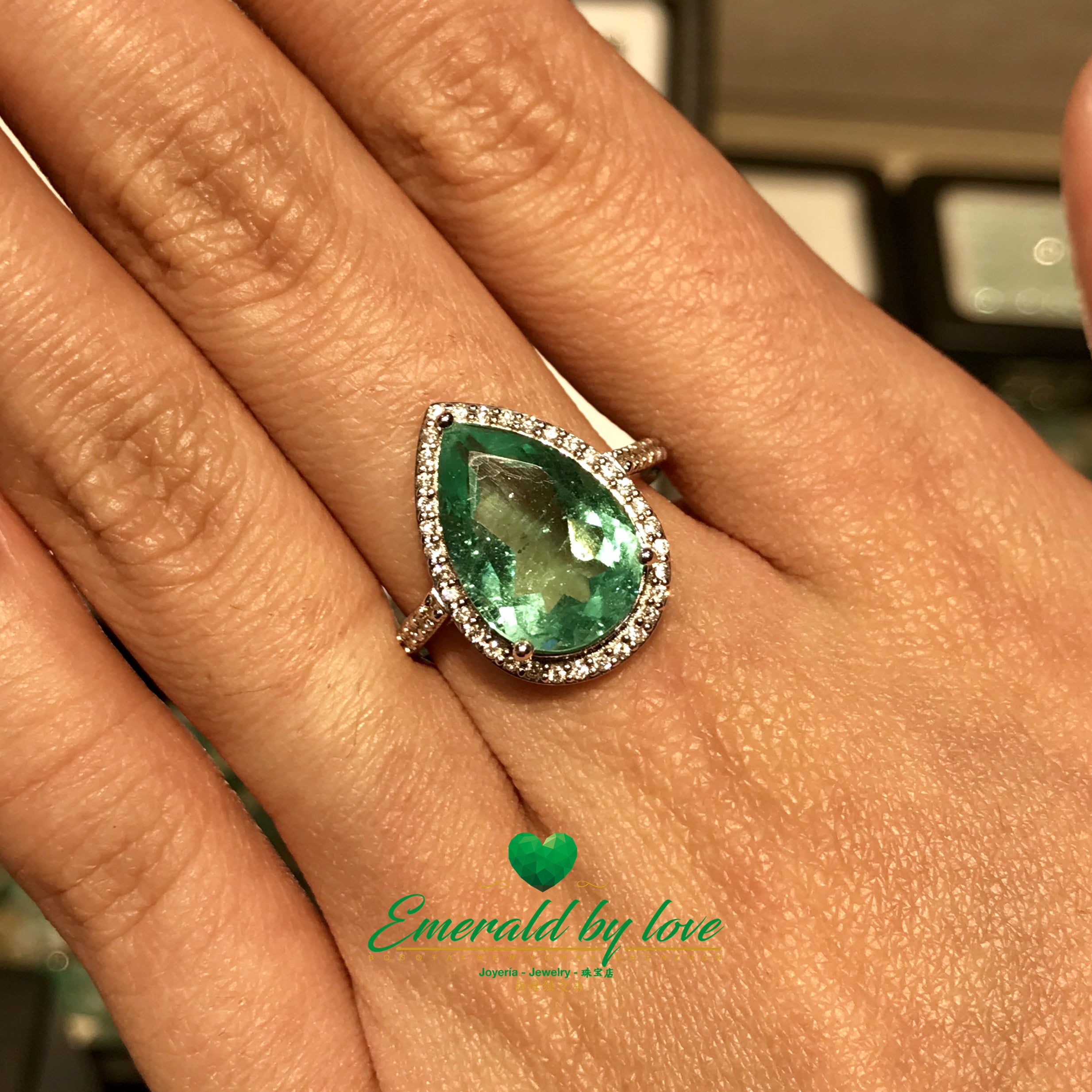 Sparkling Teardrop Halo Colombian Emerald Ring in 18k White Gold