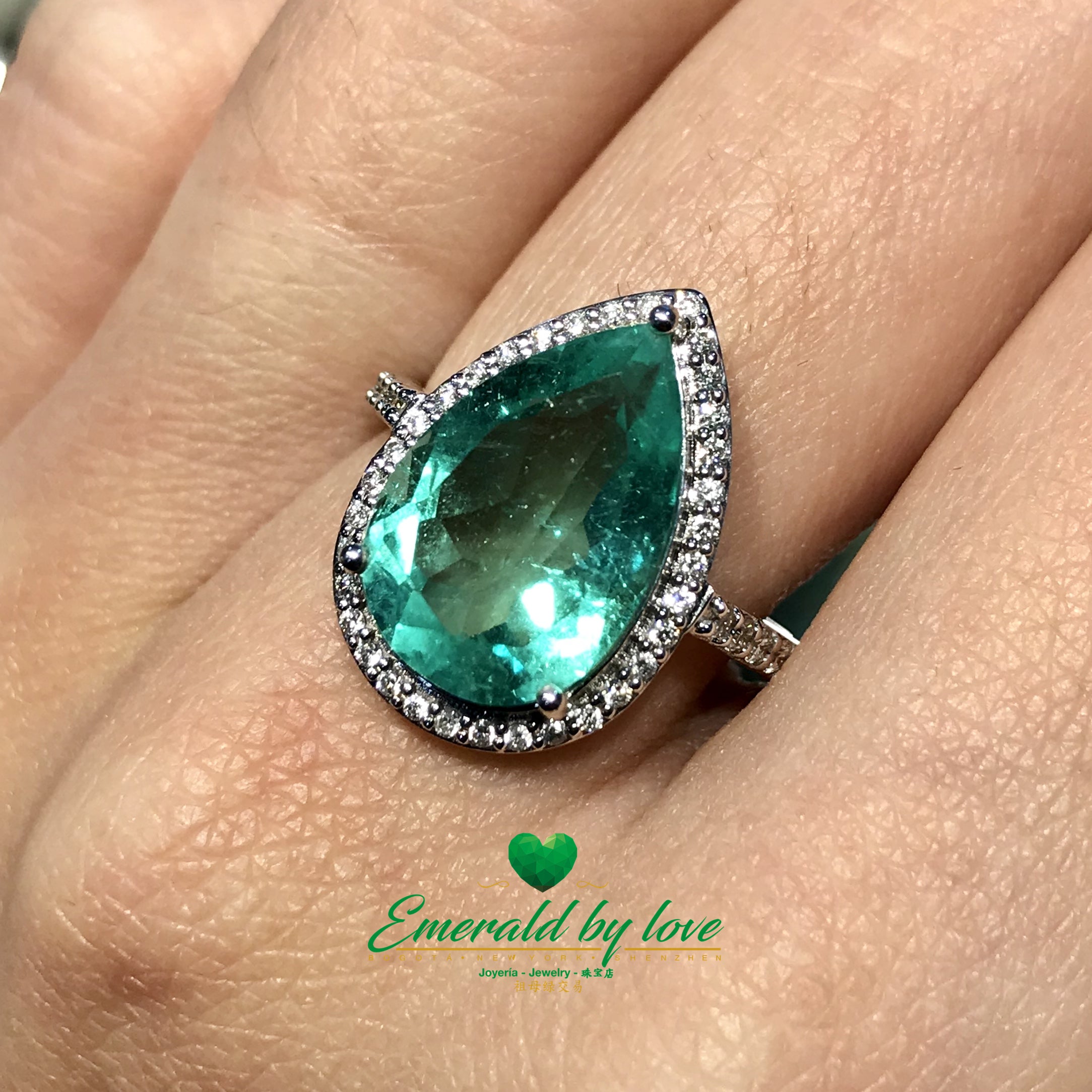 Sparkling Teardrop Halo Colombian Emerald Ring in 18k White Gold