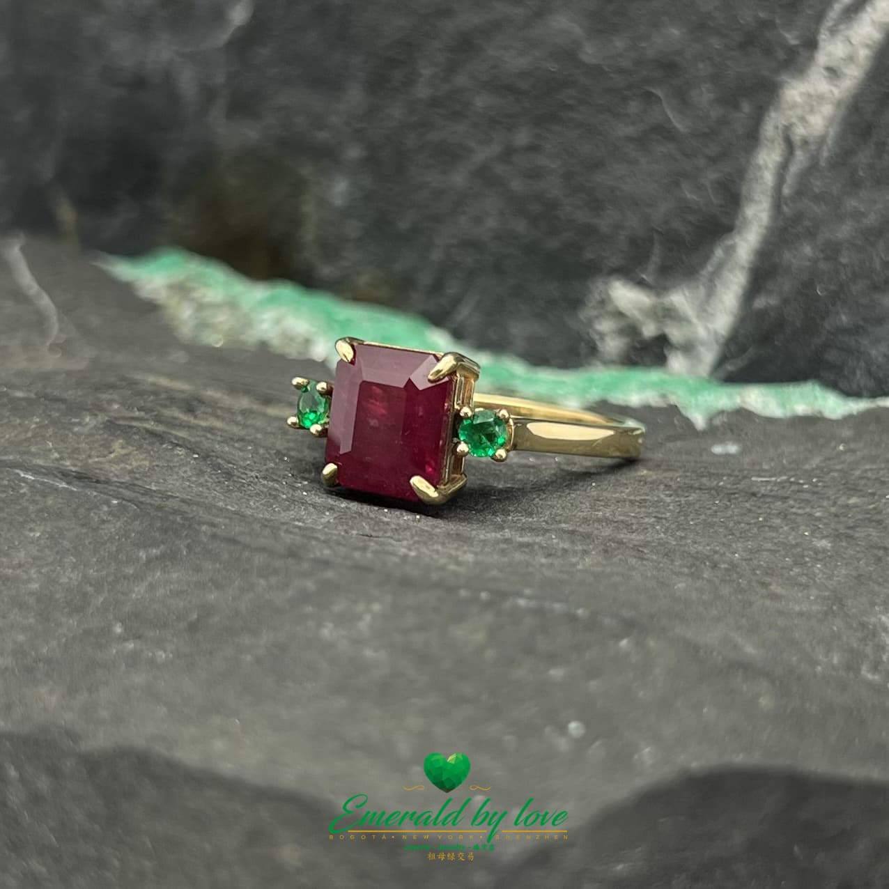 Royal Radiance: Yellow Gold Ring with Central Ruby and Flanking Round Emeralds