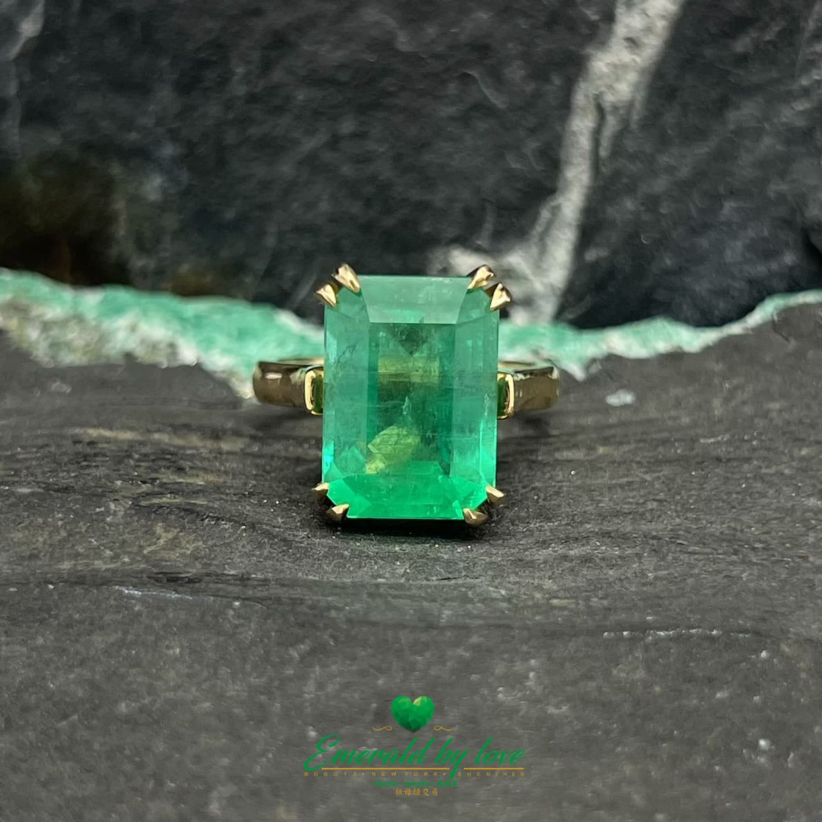 Magnificent Majesty: Yellow Gold Ring with Spectacular Emerald-Cut Emerald Centerpiece
