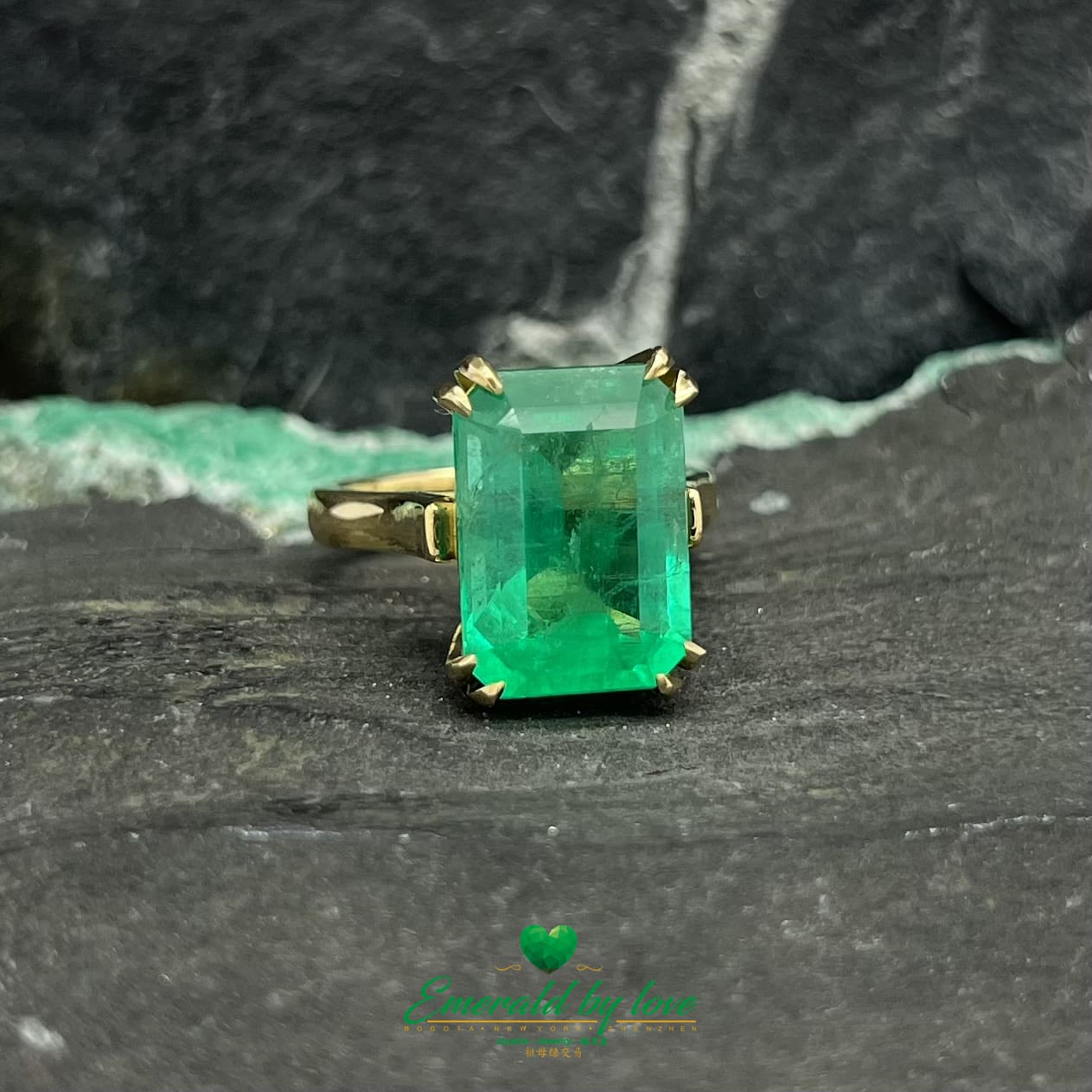 Magnificent Majesty: Yellow Gold Ring with Spectacular Emerald-Cut Emerald Centerpiece