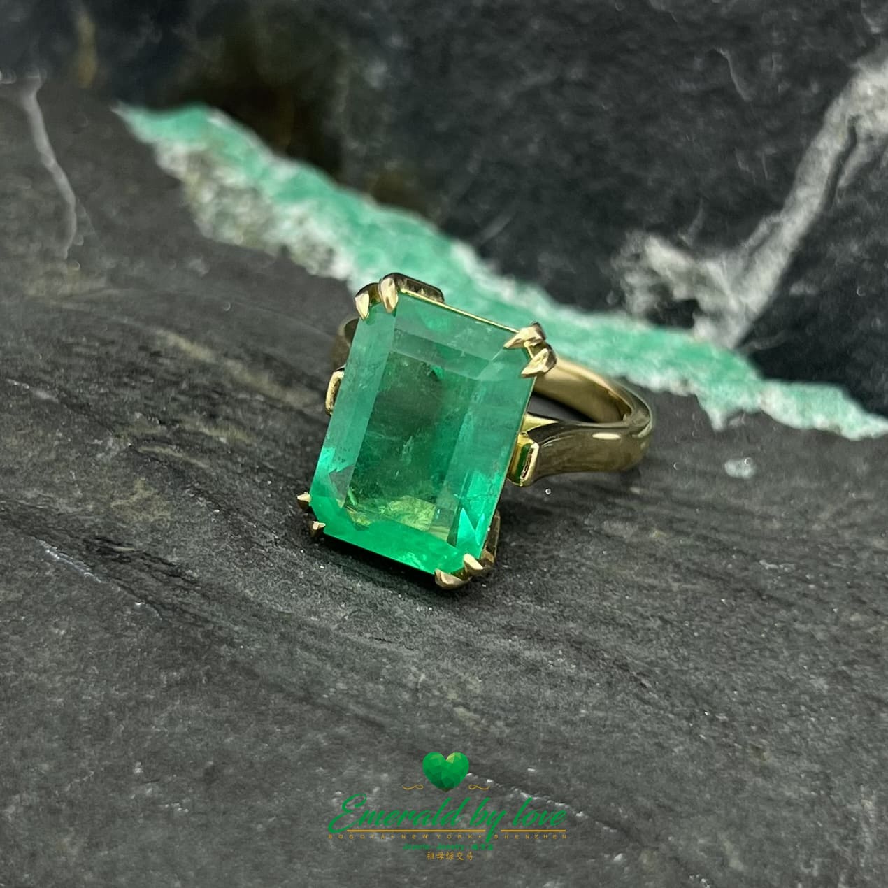 Magnificent Majesty: Yellow Gold Ring with Spectacular Emerald-Cut Emerald Centerpiece