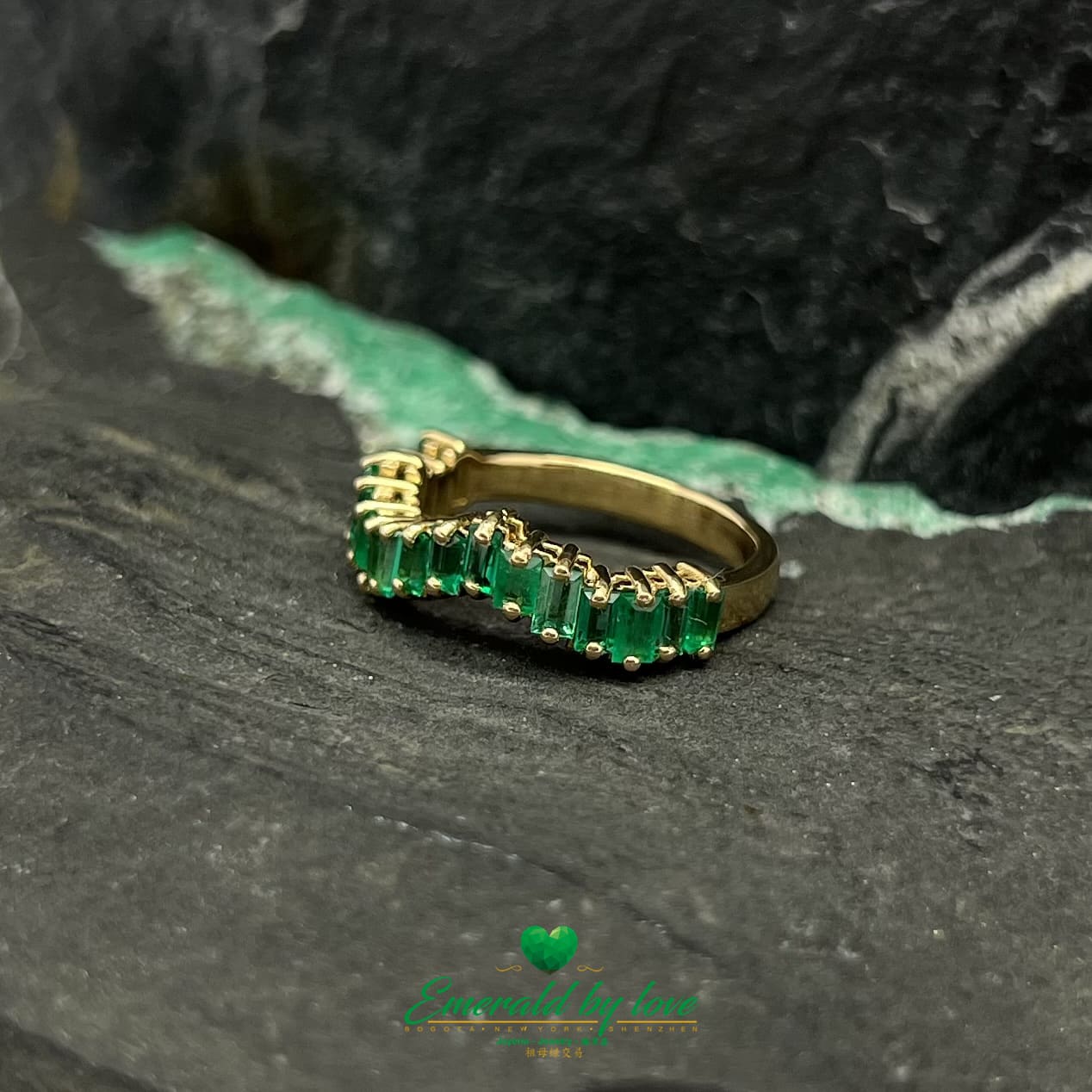 Yellow, Rose and White Gold Ring with Baguette Emeralds Encircling the Band