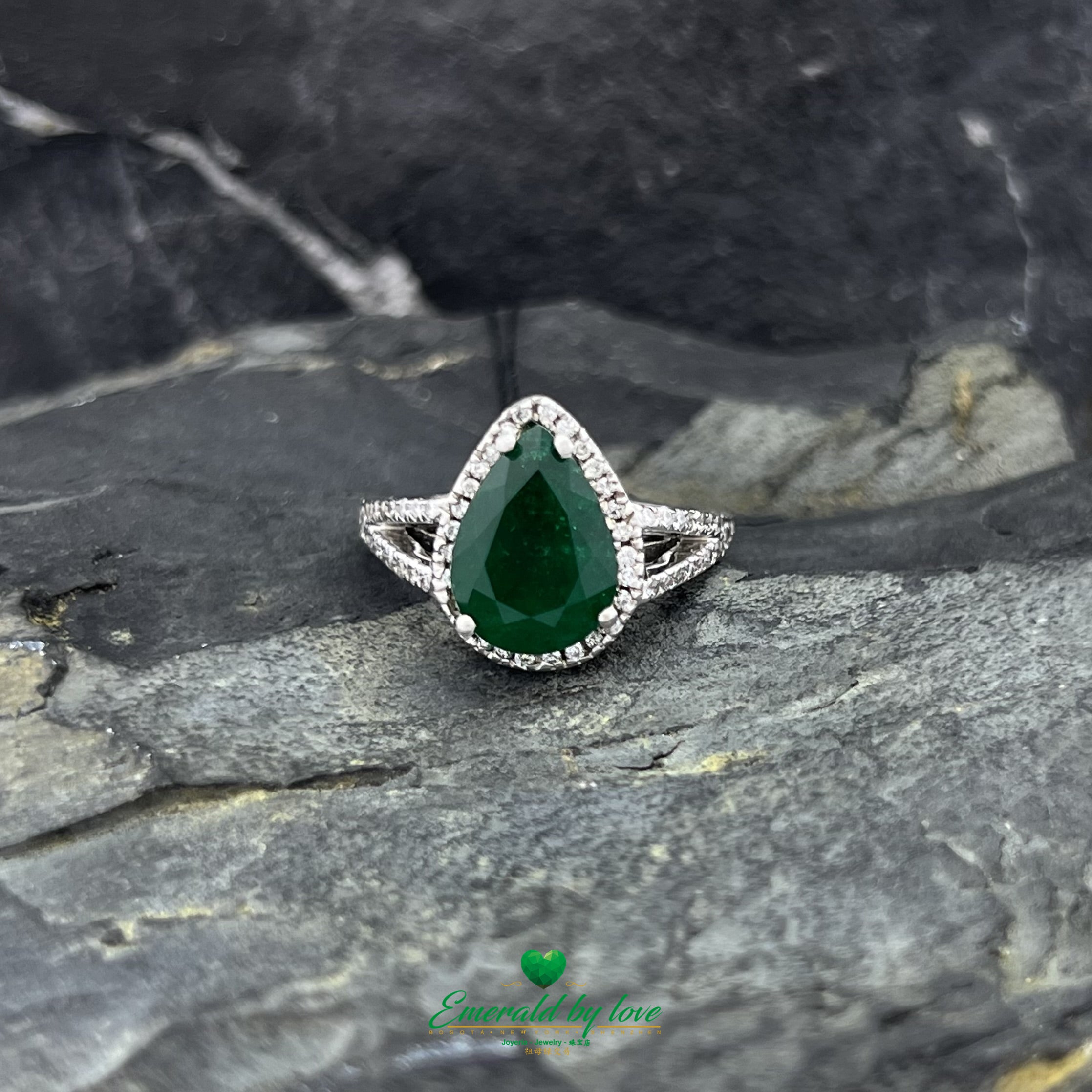 White Gold Ring with Dark Green Emerald Surrounded by Diamonds