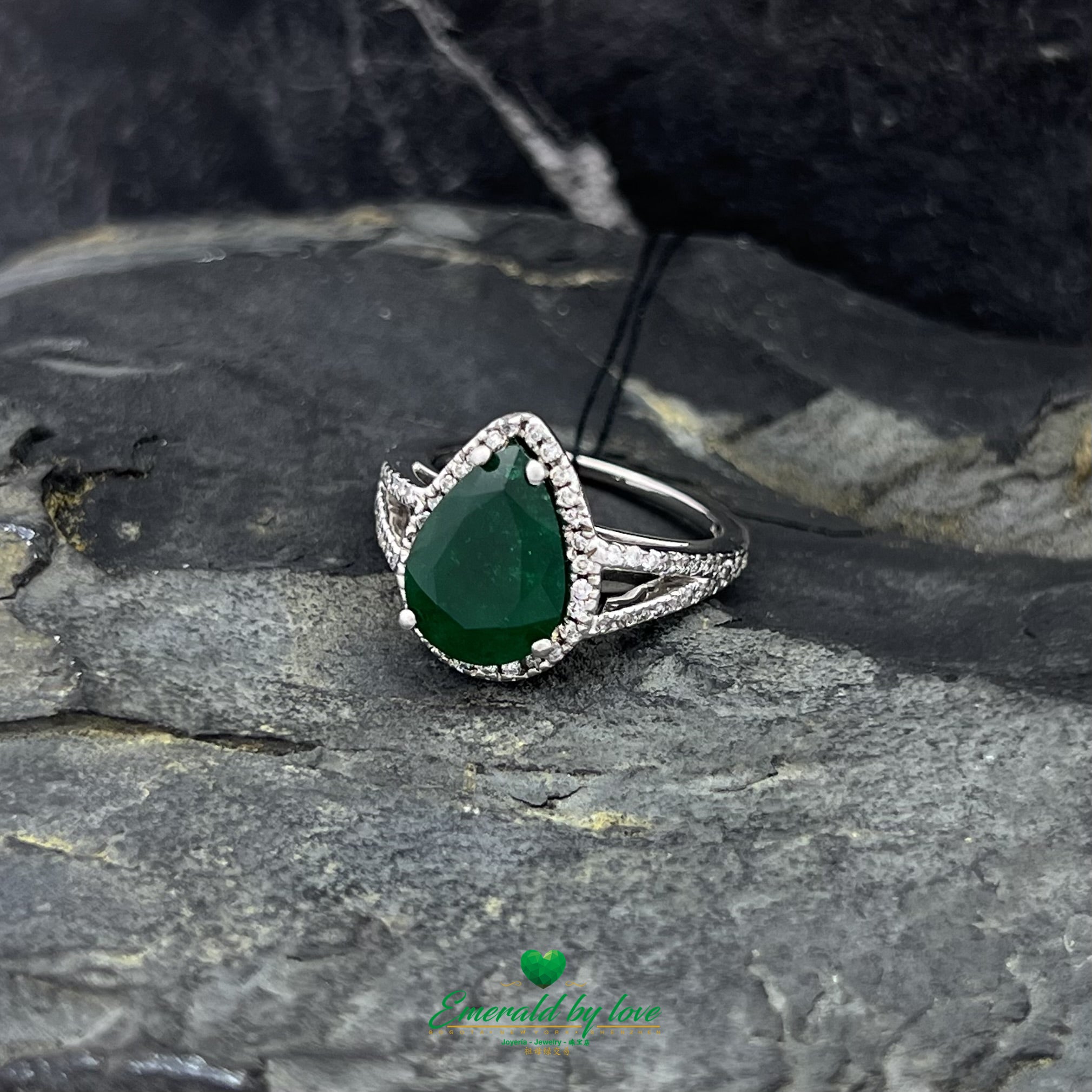 White Gold Ring with Dark Green Emerald Surrounded by Diamonds