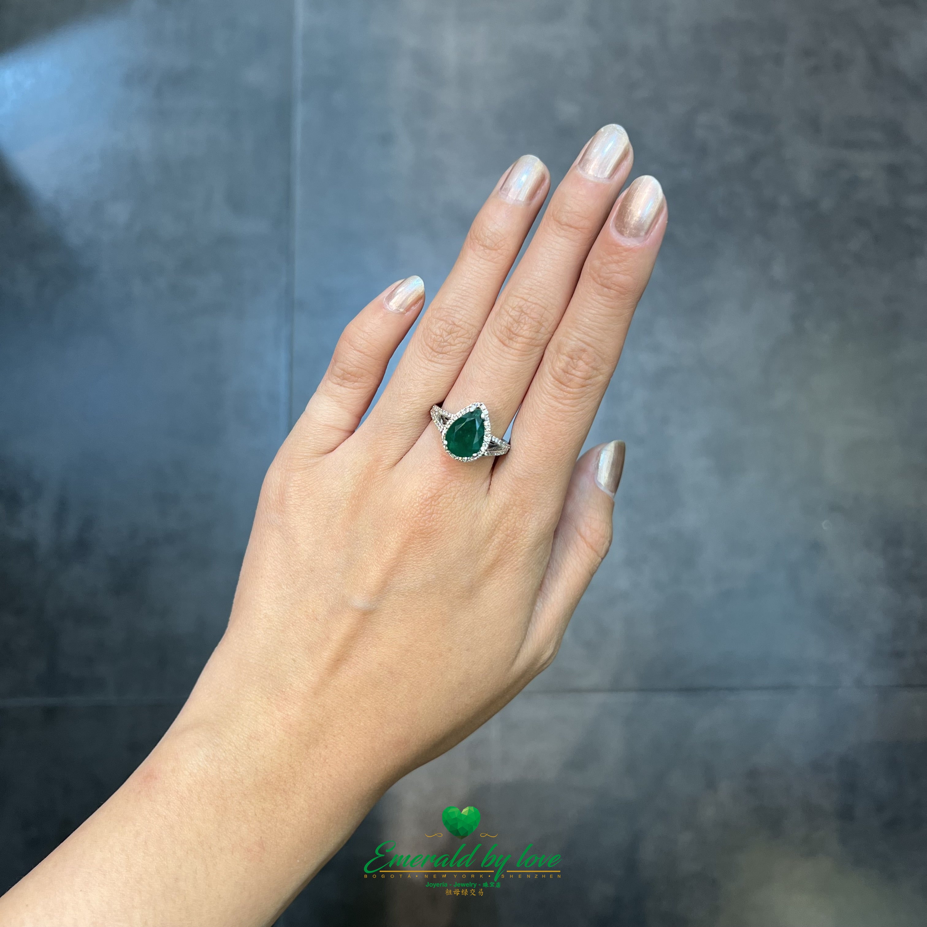 White Gold Ring with Dark Green Emerald Surrounded by Diamonds