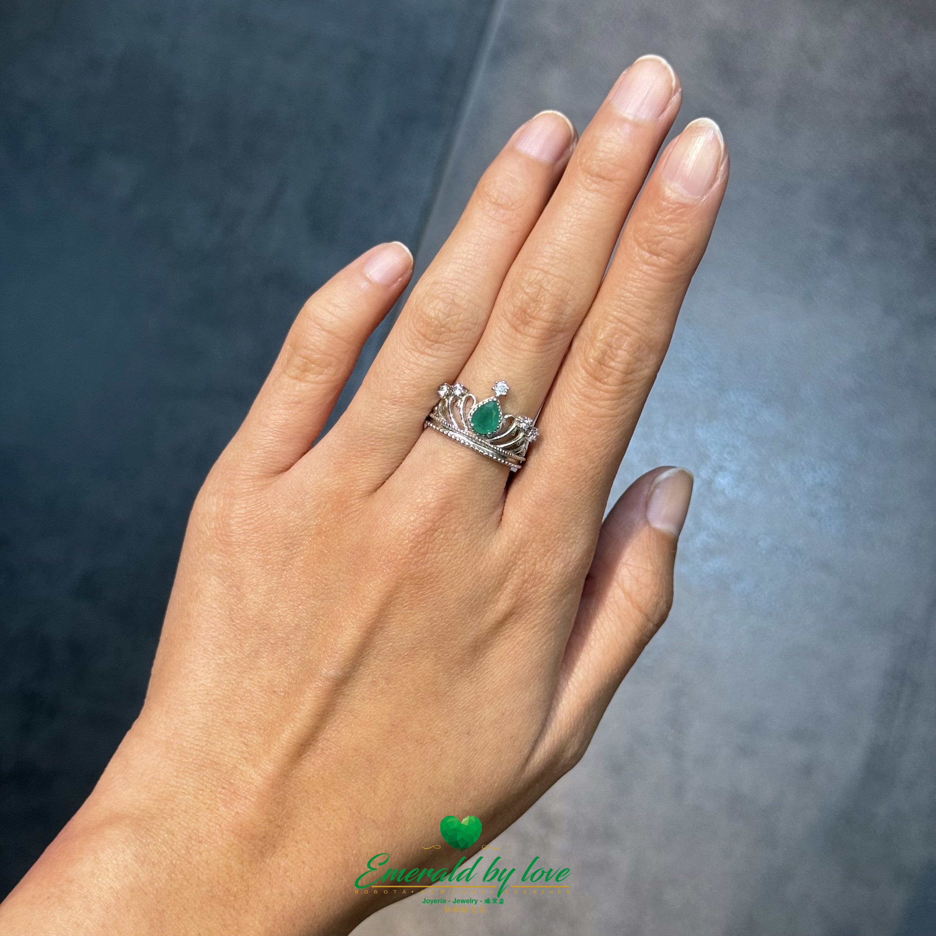 Crown-Inspired Ring with Pear-Shaped Emerald Center and Decorative Zircons
