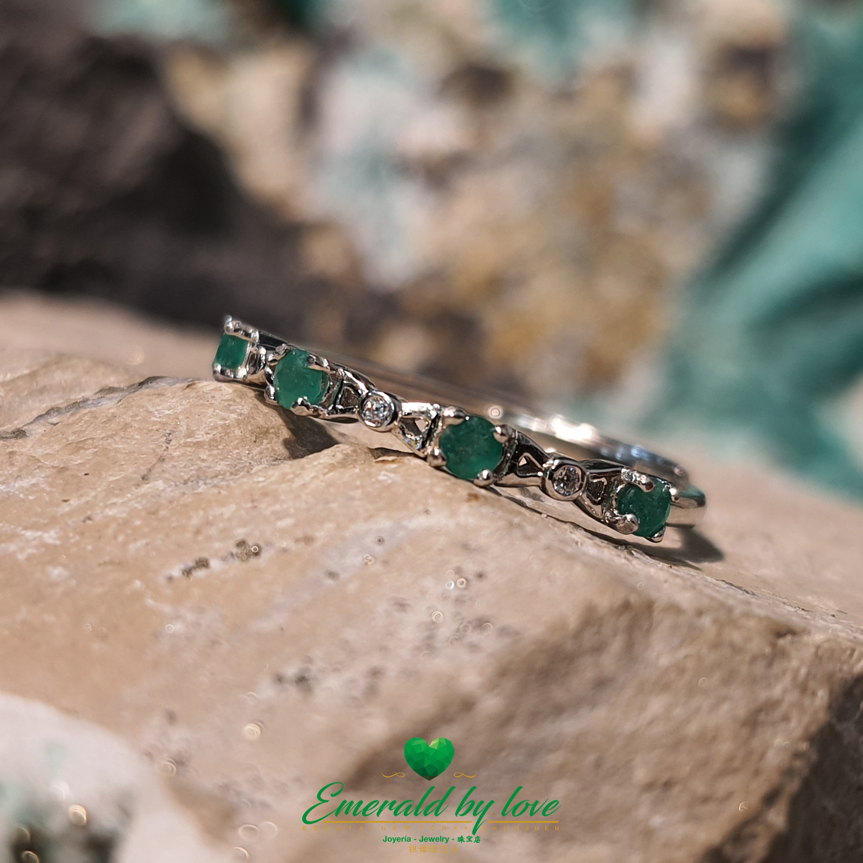 Minimalist Band Ring with Tiny Round Emeralds Connected by Triangular Bow Details