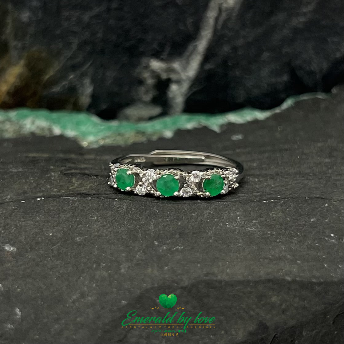 Curved Silver Band Ring with Interspersed Emeralds and Zirconia Accents