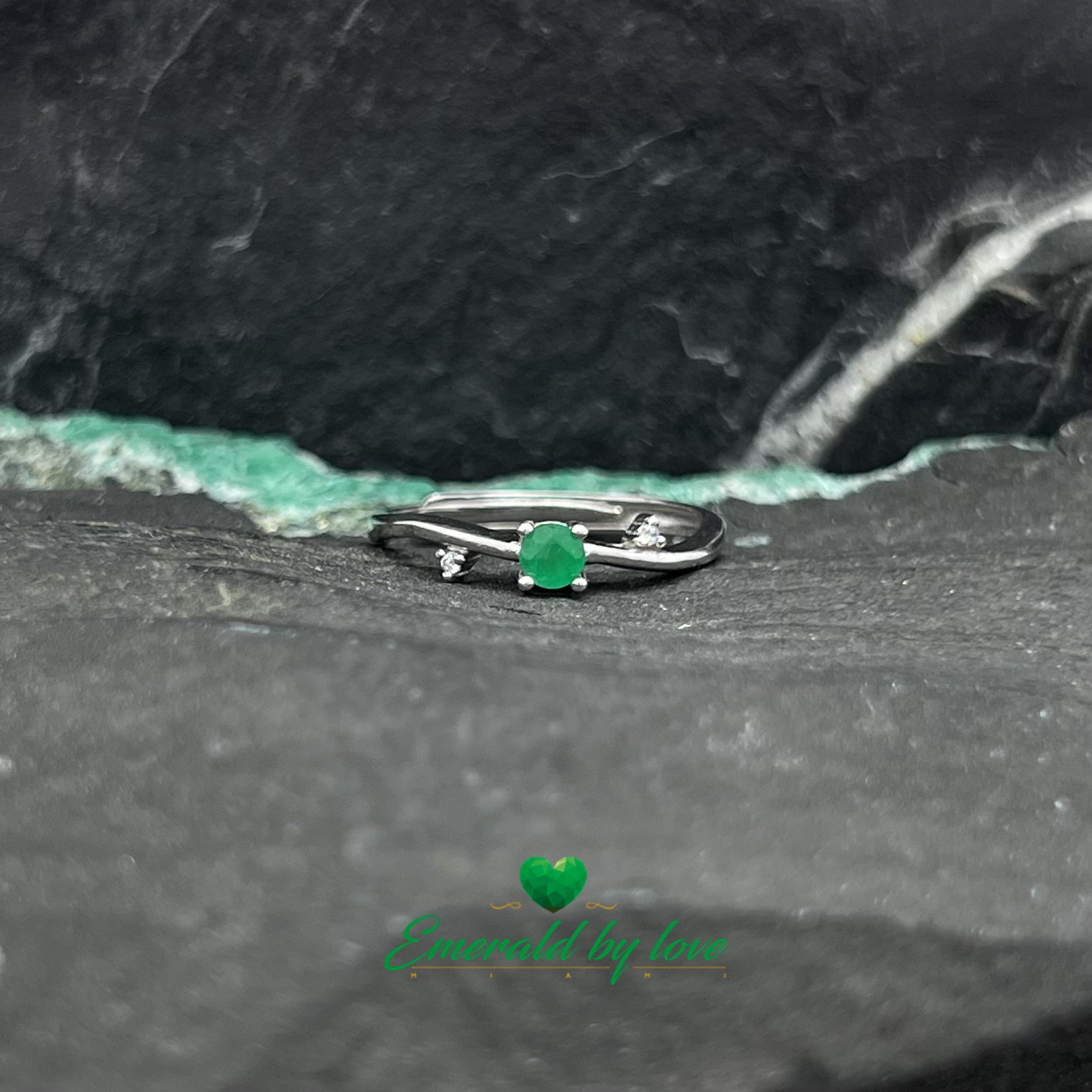 Delicate Ring with Central Round Emerald and Side Zircon Accents