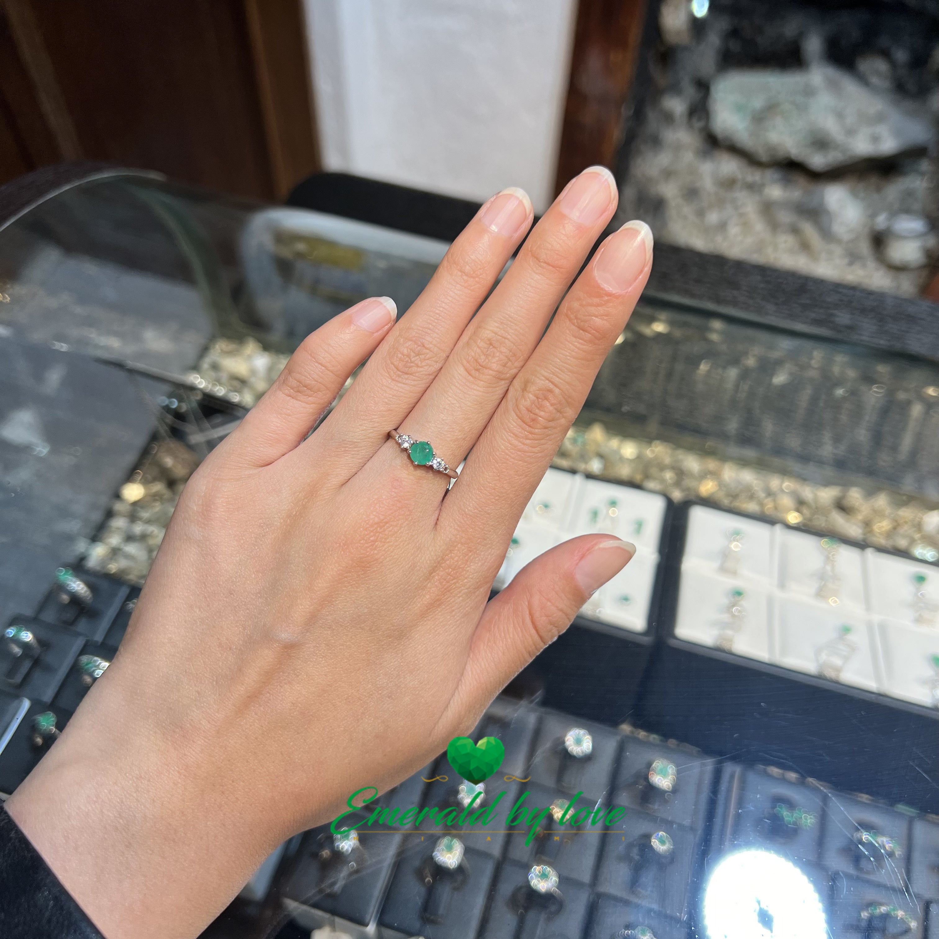 Classy Ring with 0.42ct Central Round Emerald and Matching Side Zircons