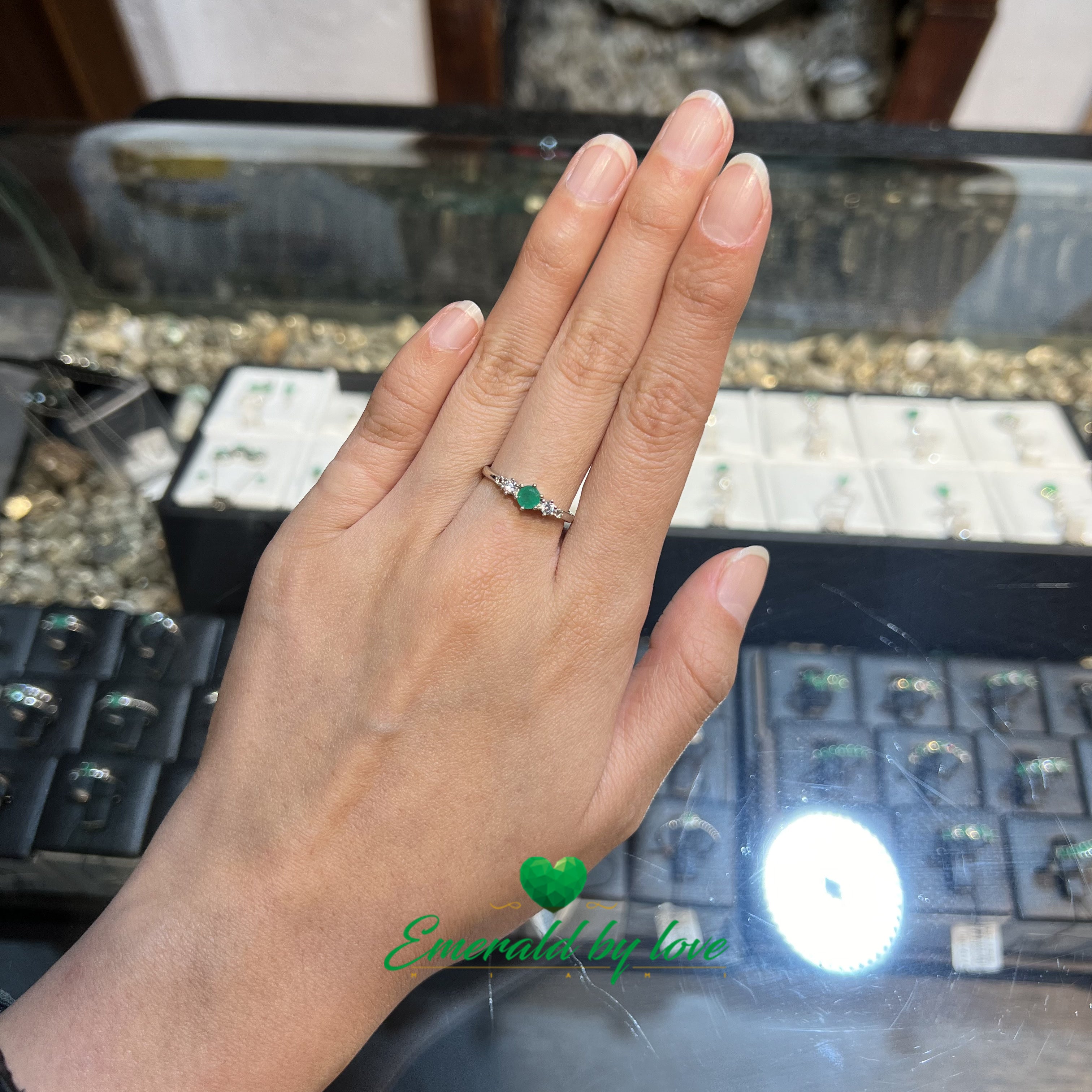 Elegant Thin Ring with Central Round Emerald of 0,25 ct and Matching Side Zircons